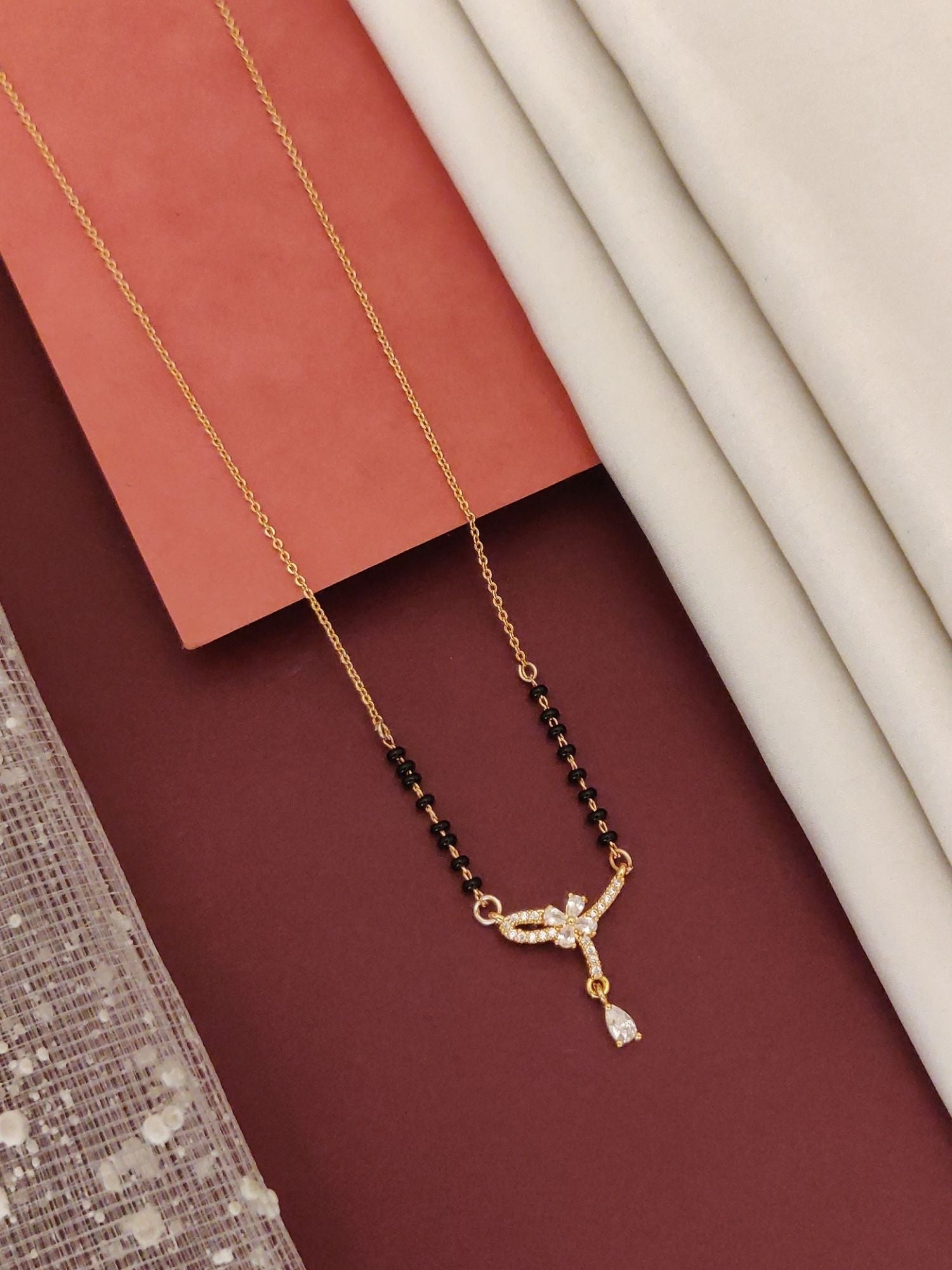 Elegant rose gold plated mangalsutra with intricate diamond-like design and black beads