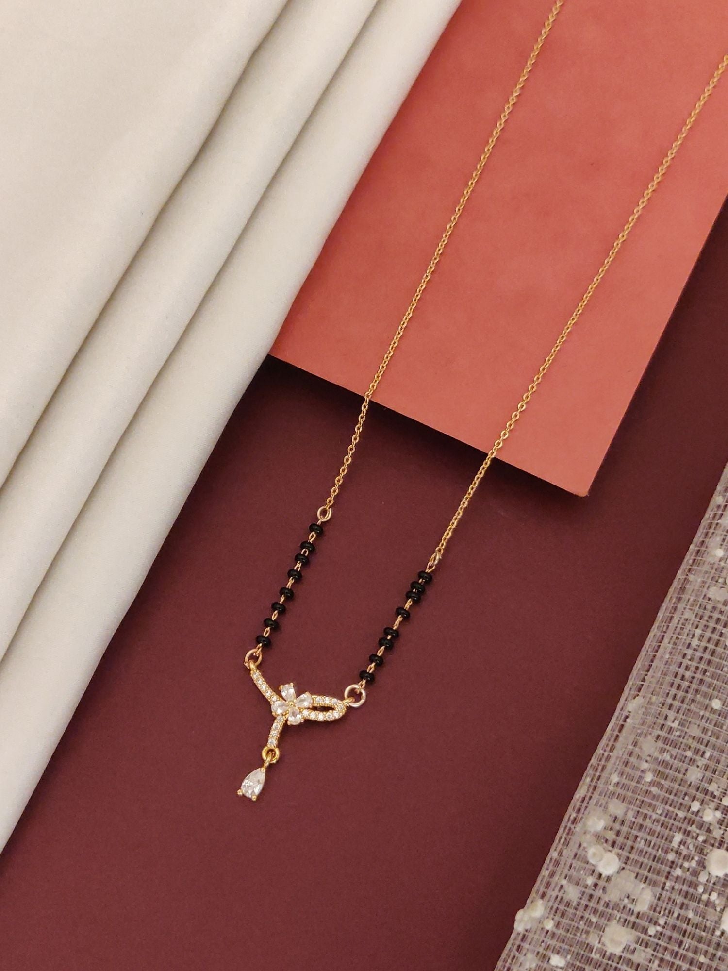 Elegant rose gold plated mangalsutra with crystal accents and black beads for modern brides