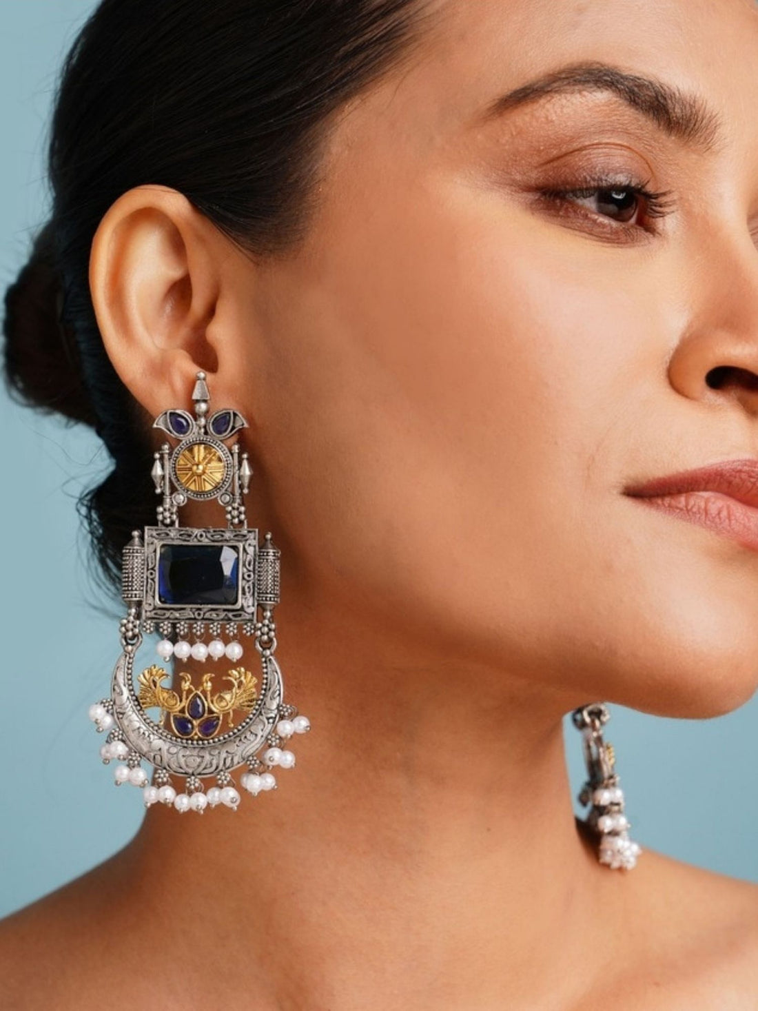 Elegant model wearing a Set Of 2 German Silver Earring Combo with intricate designs and embellishments