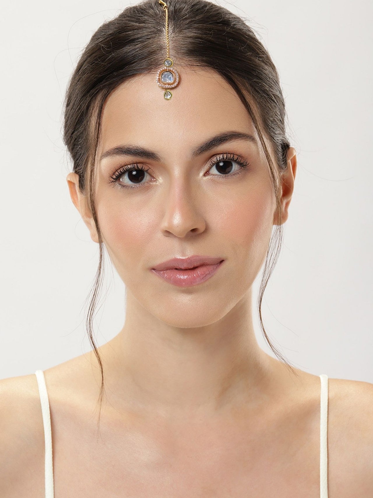 Elegant woman wearing a Set Of 2 Silver Plated American Diamond Maangtikka for a traditional look