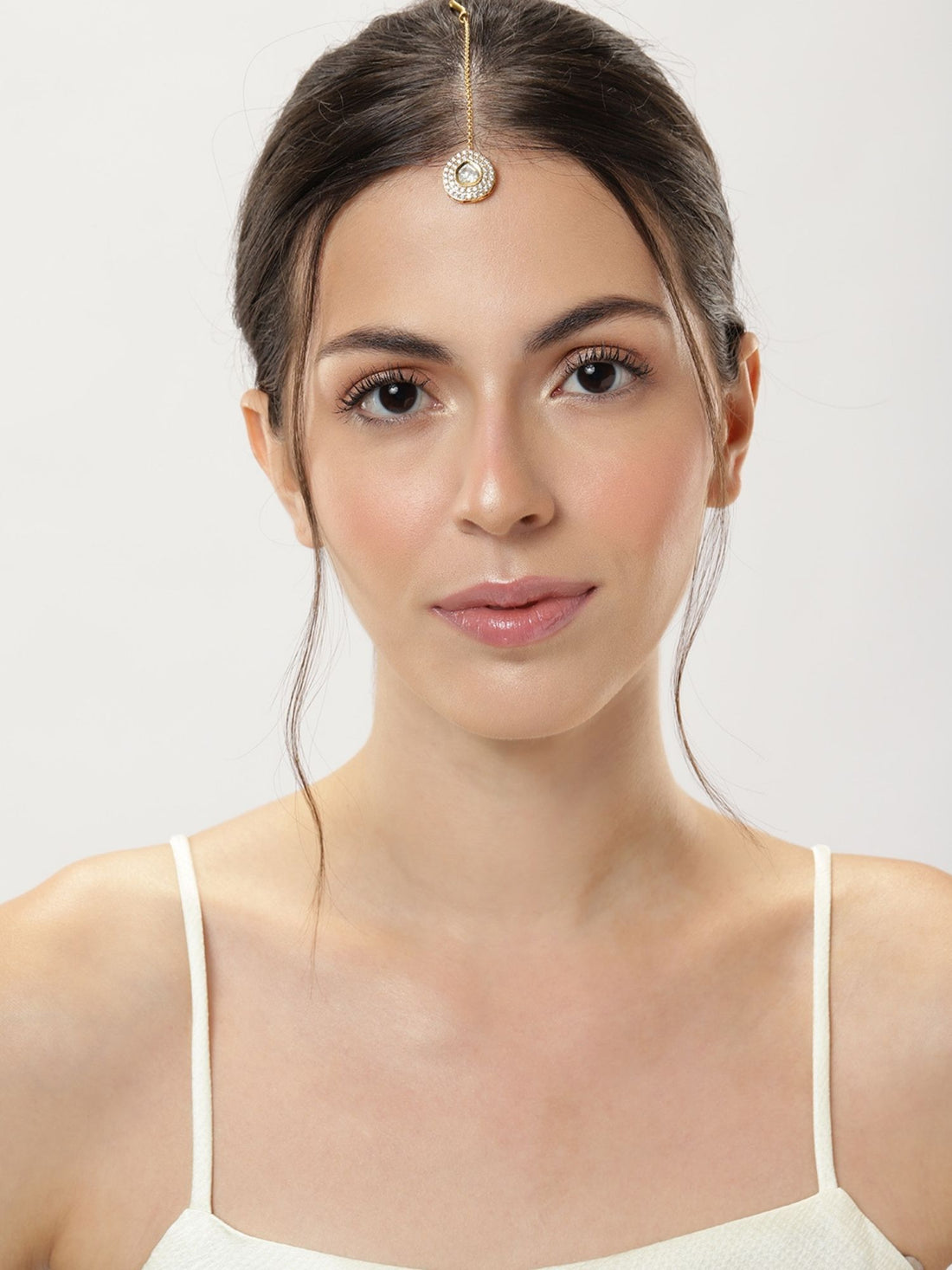 Elegant woman wearing a Set Of 2 Silver Plated American Diamond Maangtikka for a traditional look