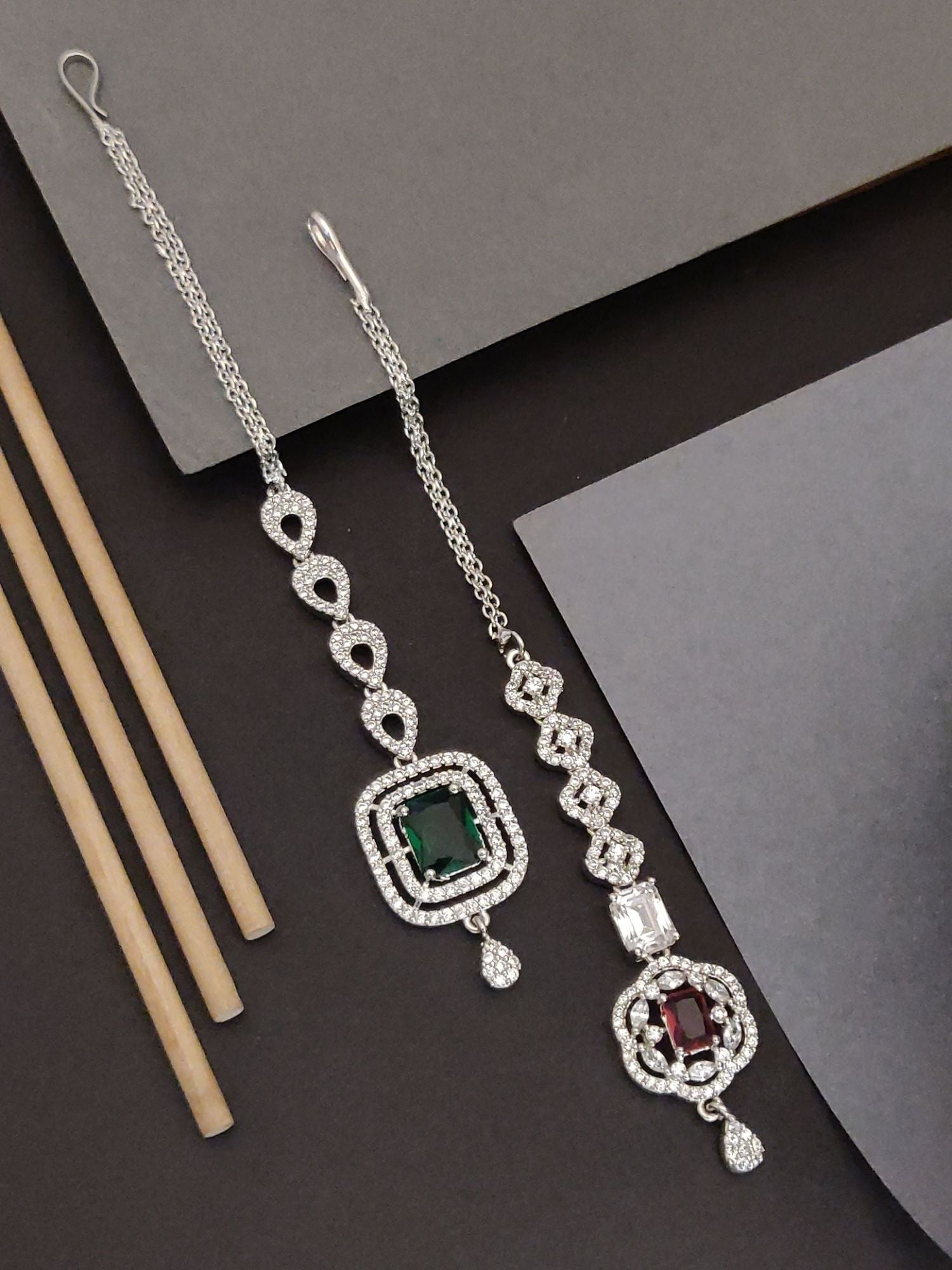 Set Of 2 Silver Plated American Diamond Maangtikka featuring green and maroon stones in elegant designs