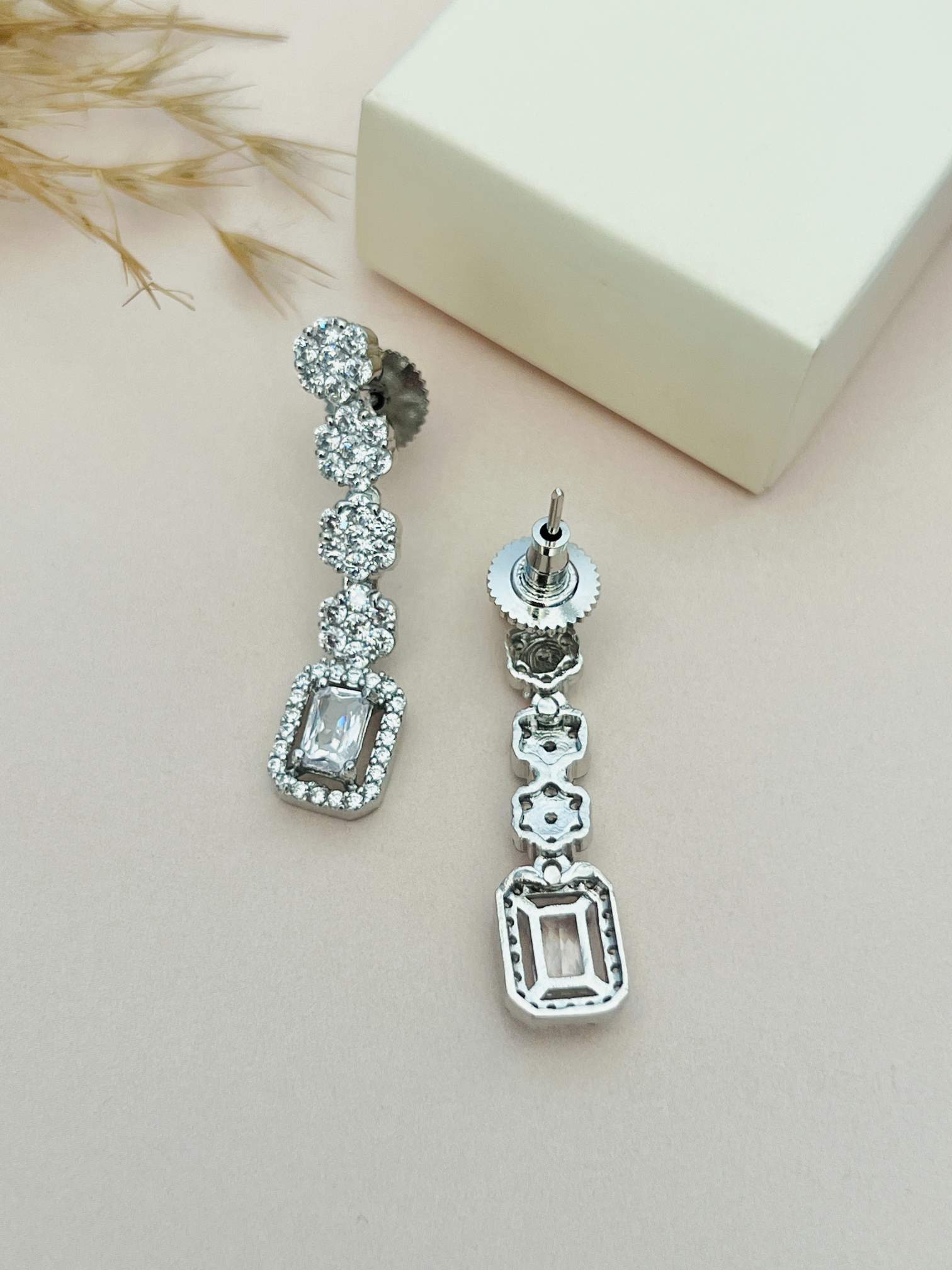 Silver Plated American Diamond Double Layer Necklace earrings with sparkling stones on a beige background