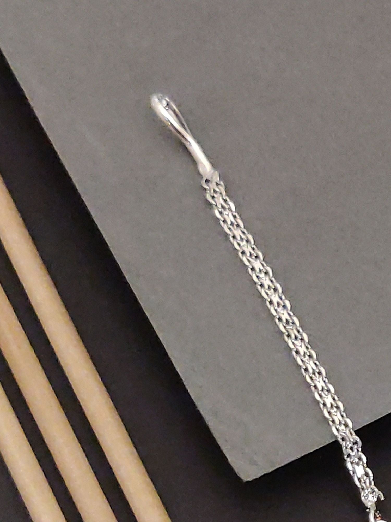 Close-up of a Silver Plated American Diamond MaangTikka showcasing its intricate design and chain detail