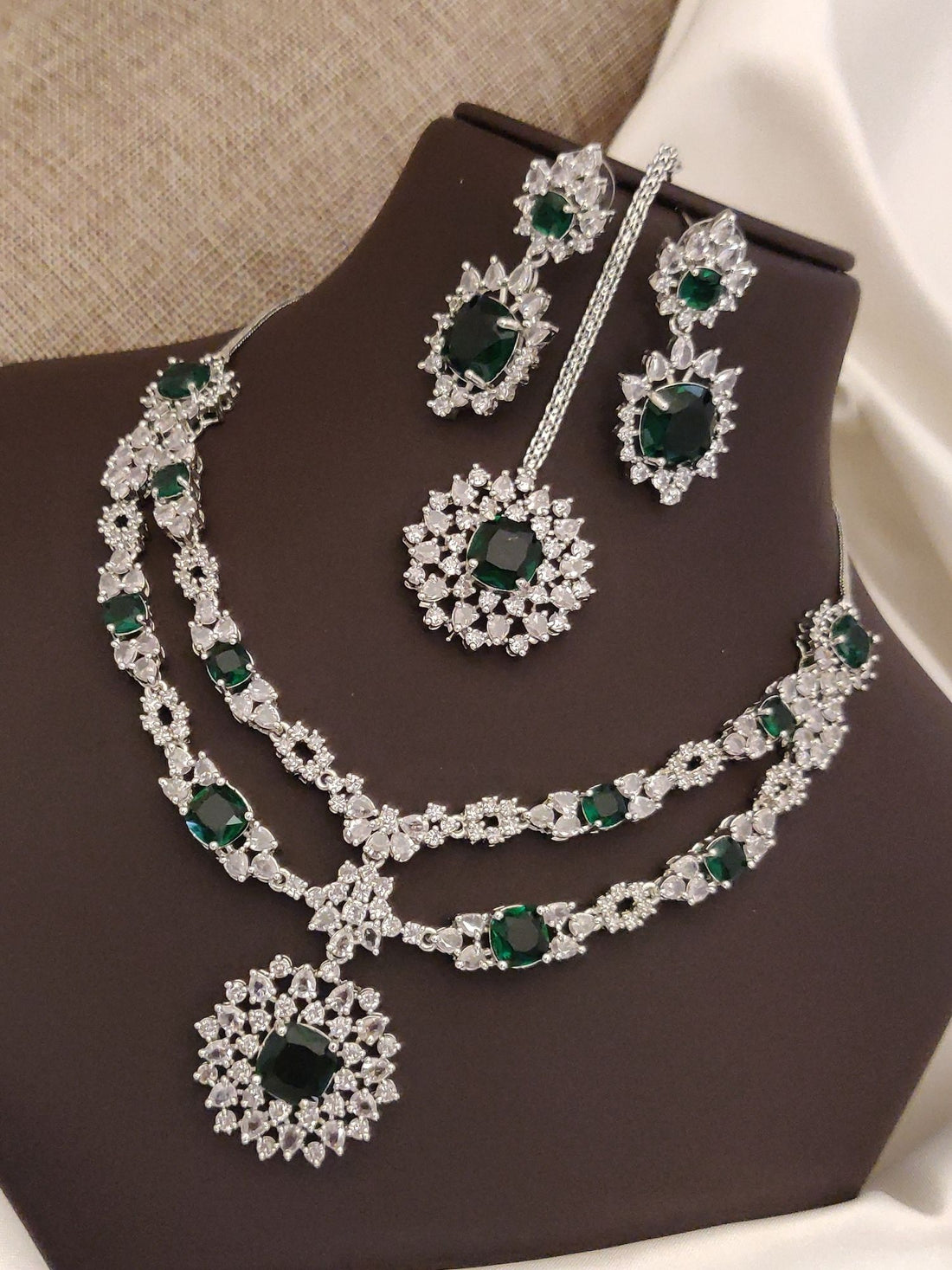 Elegant silver plated American diamond necklace set with emerald accents and matching earrings