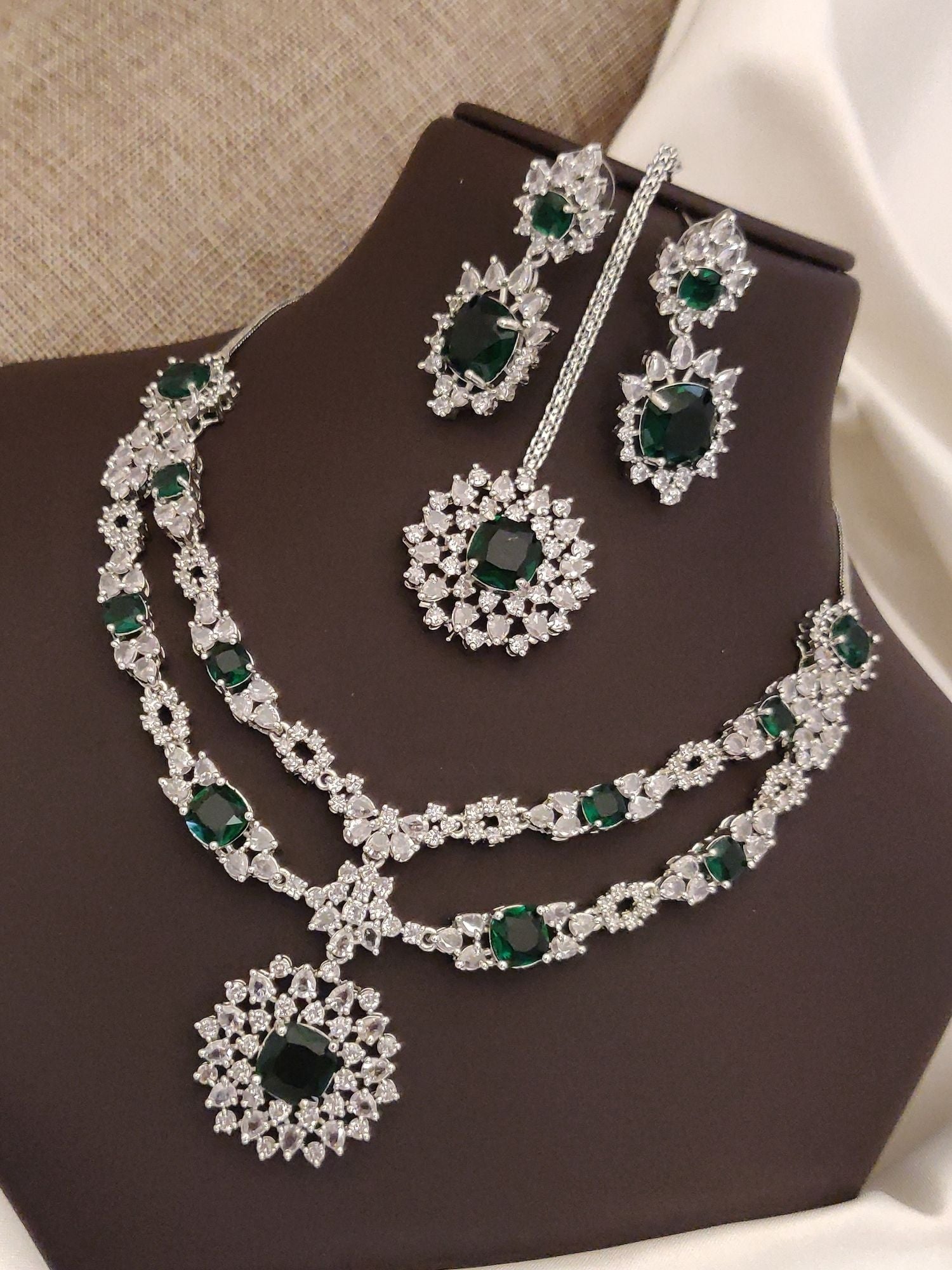 Elegant silver plated American diamond necklace set with emerald accents and matching earrings