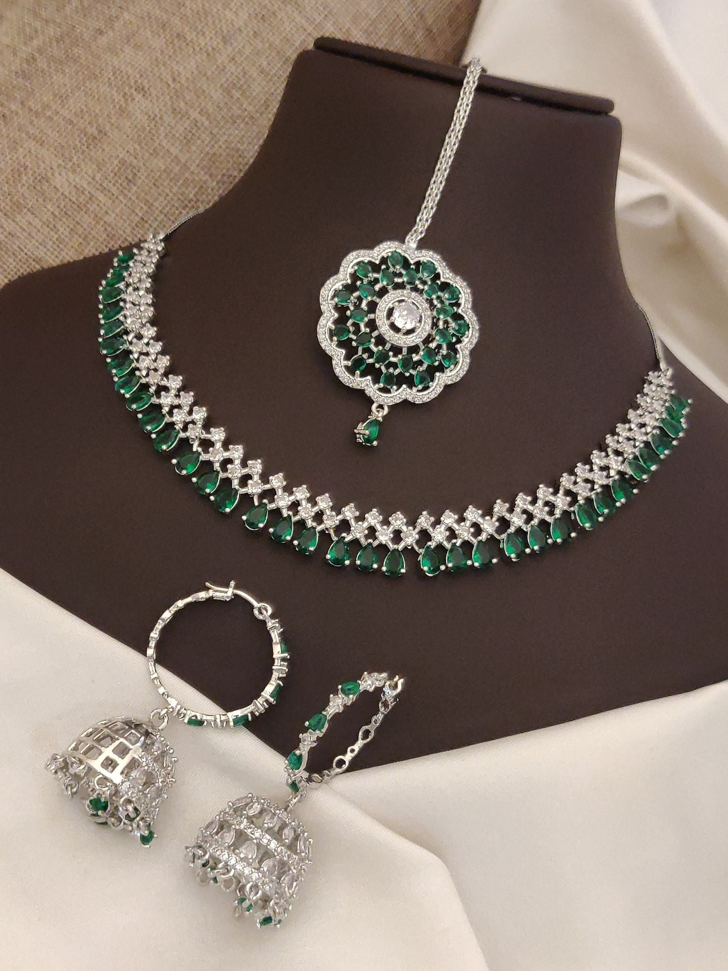 Elegant silver plated American diamond necklace set with green accents and matching earrings