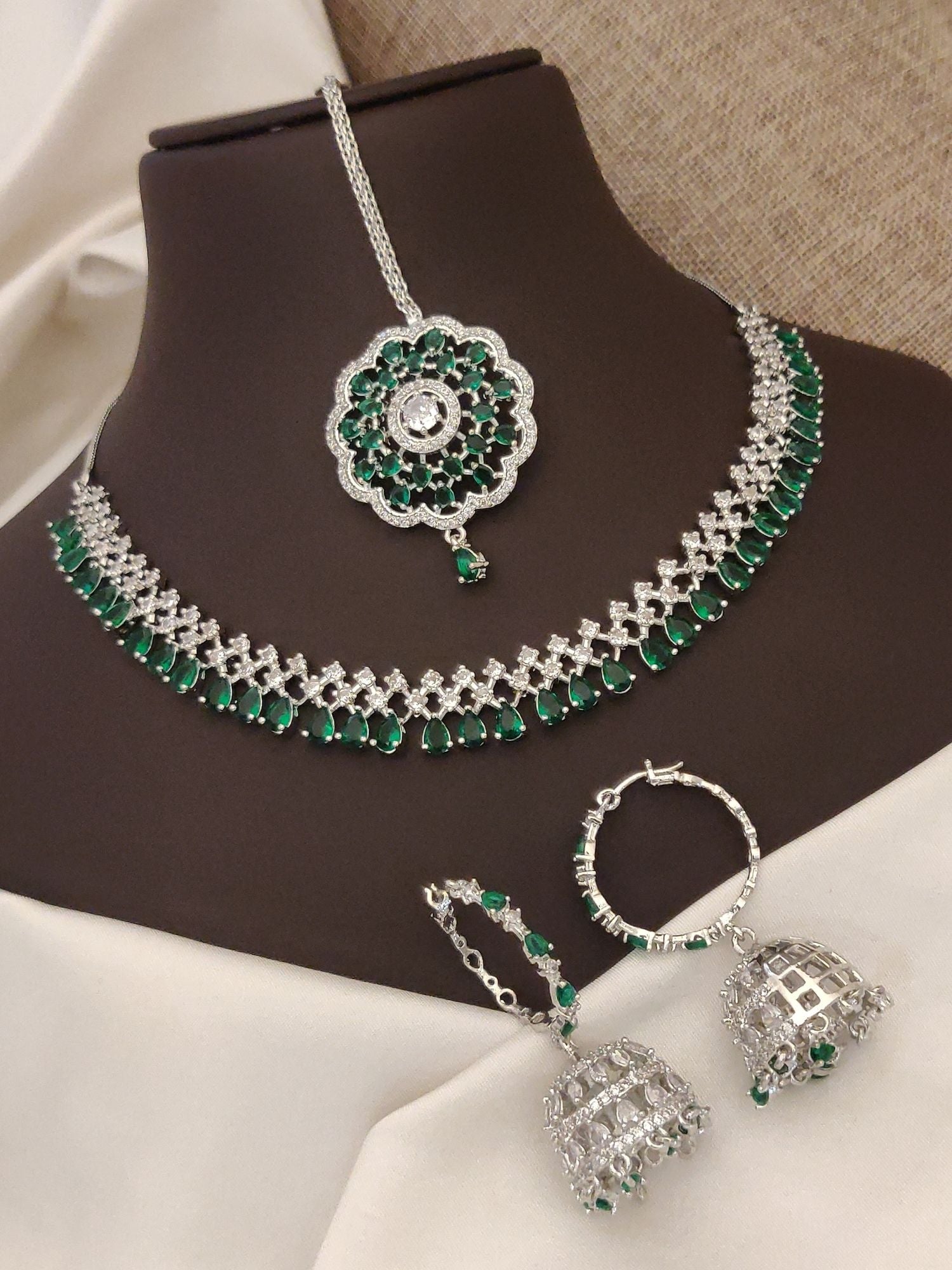 Elegant silver plated American diamond necklace set with green stones and matching earrings