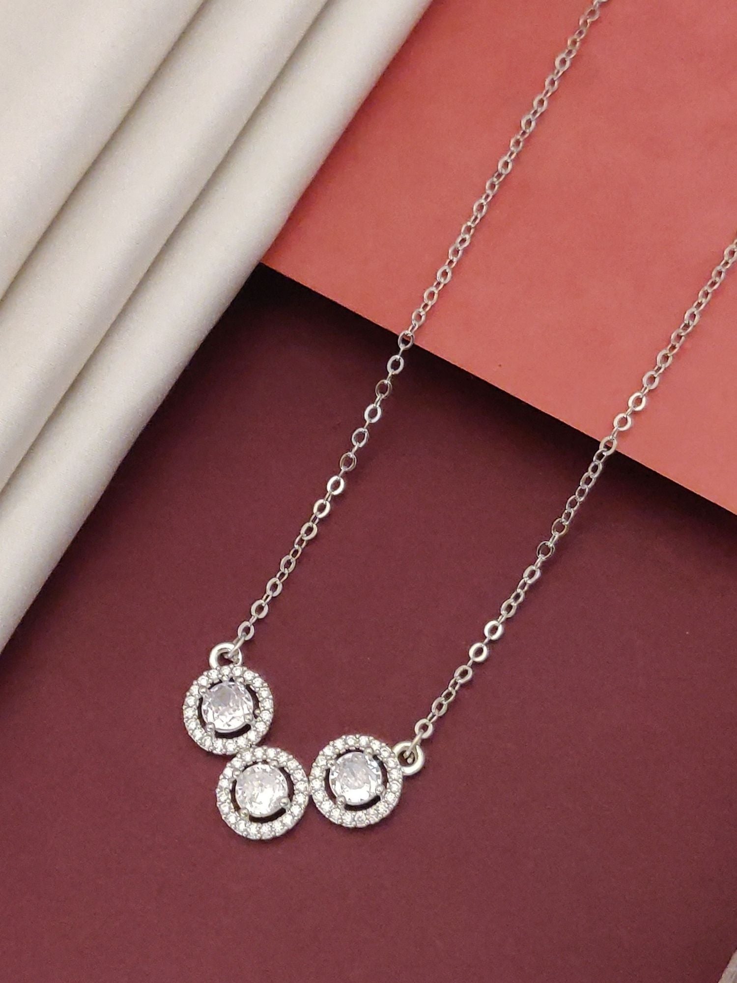 Elegant silver plated cz diamond pendant chain featuring three sparkling circles on a stylish background