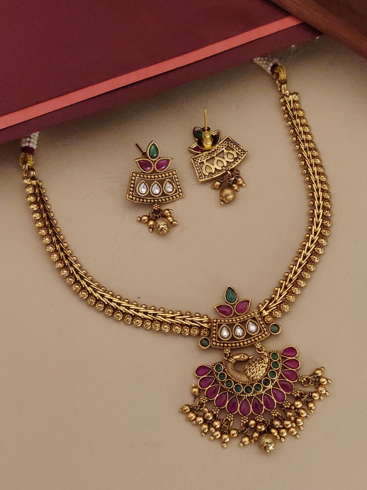 South Indian Style Kemp Stone Necklace Set with gold finish and intricate red and green stone detailing by Abdesignsjewellery