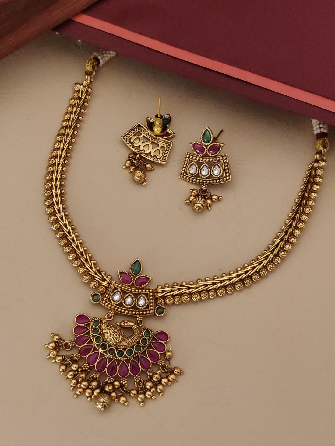 South Indian Style Kemp Stone Necklace Set with gold finish and intricate red and green stone detailing by Abdesignsjewellery
