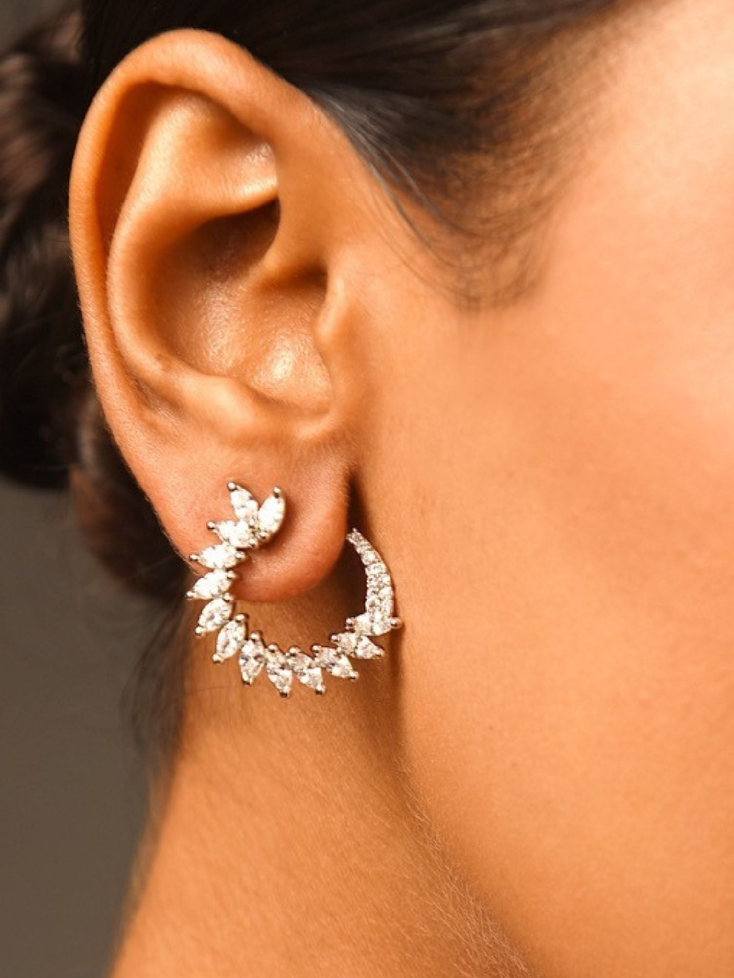 Sparkling Silver Plated American Diamond Stud Earring worn on ear showcasing intricate design and shine