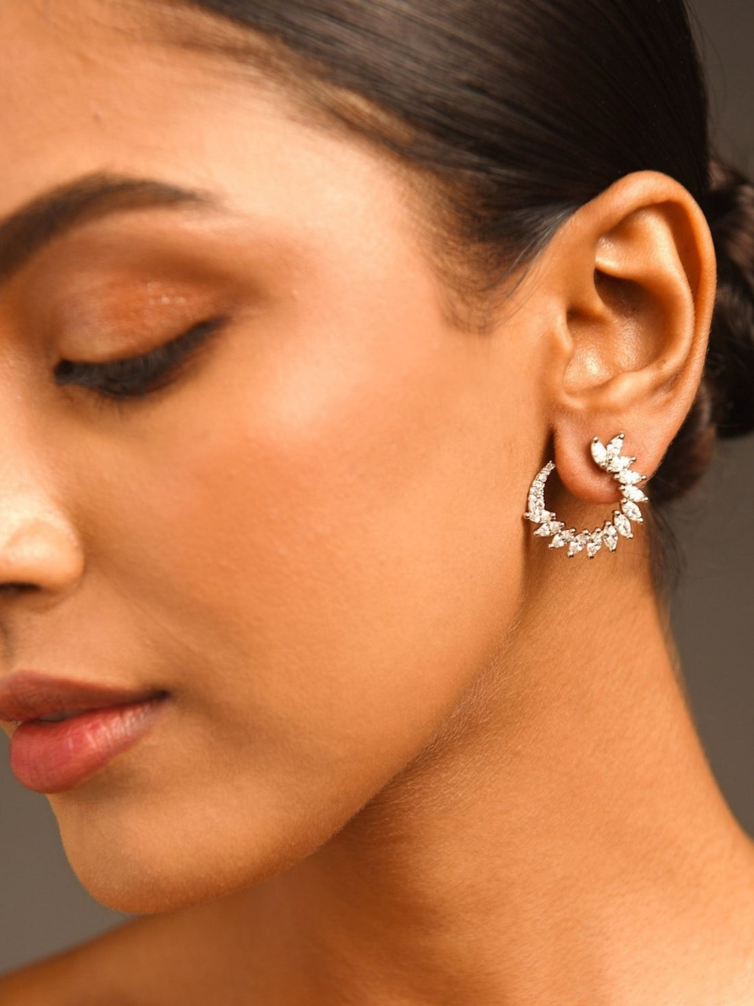 Sparkling Silver Plated American Diamond Stud Earring worn on woman’s ear by Abdesignsjewellery