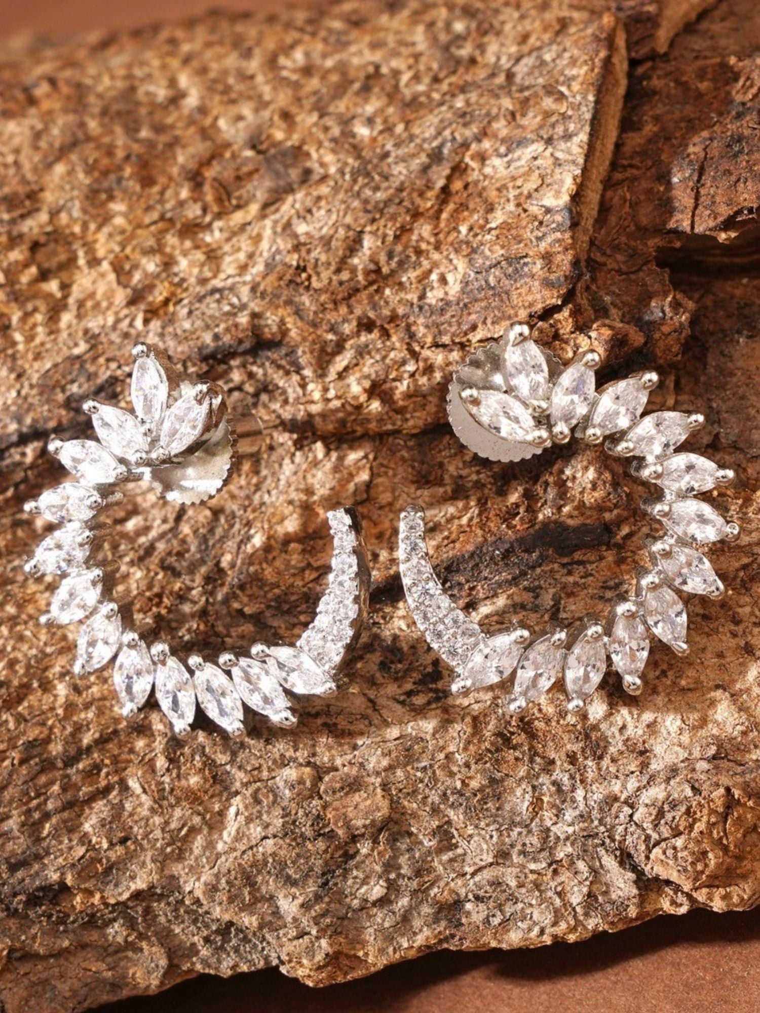 Sparkling Silver Plated American Diamond Stud Earring with marquise-shaped stones on rustic background
