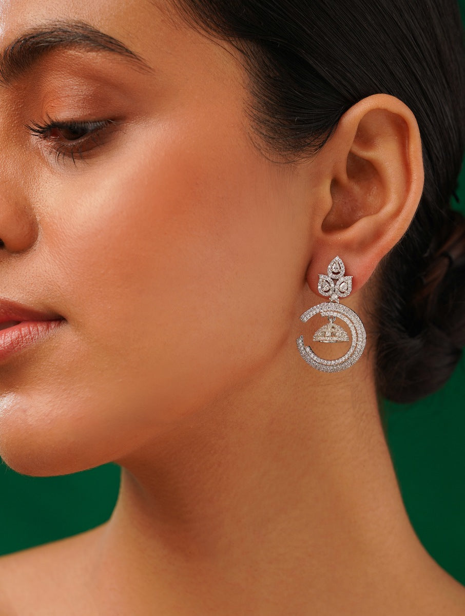 Stunning American Diamond Silver Plated Earring worn by a woman with a dark background