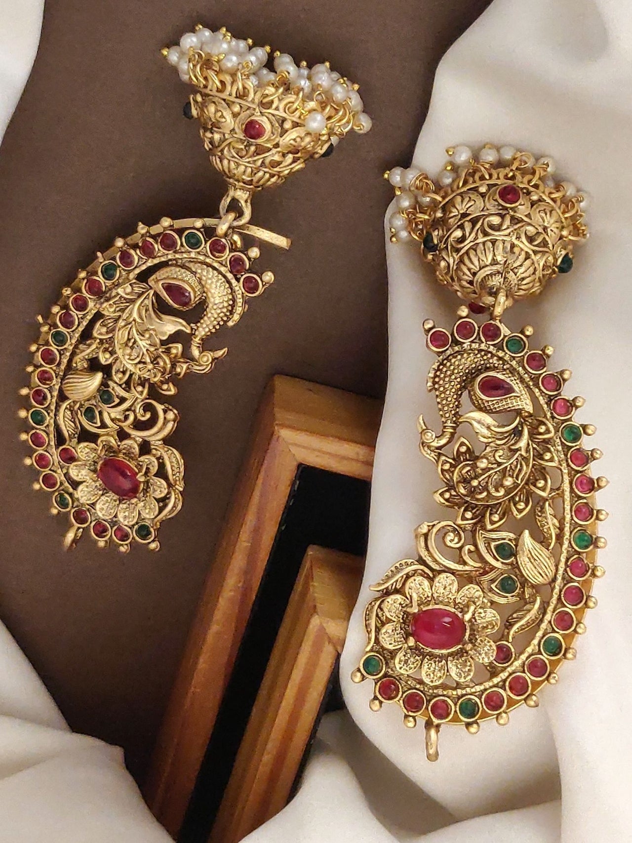 Traditional gold plated ear cuffs intricately designed with peacock motifs and colorful gemstones