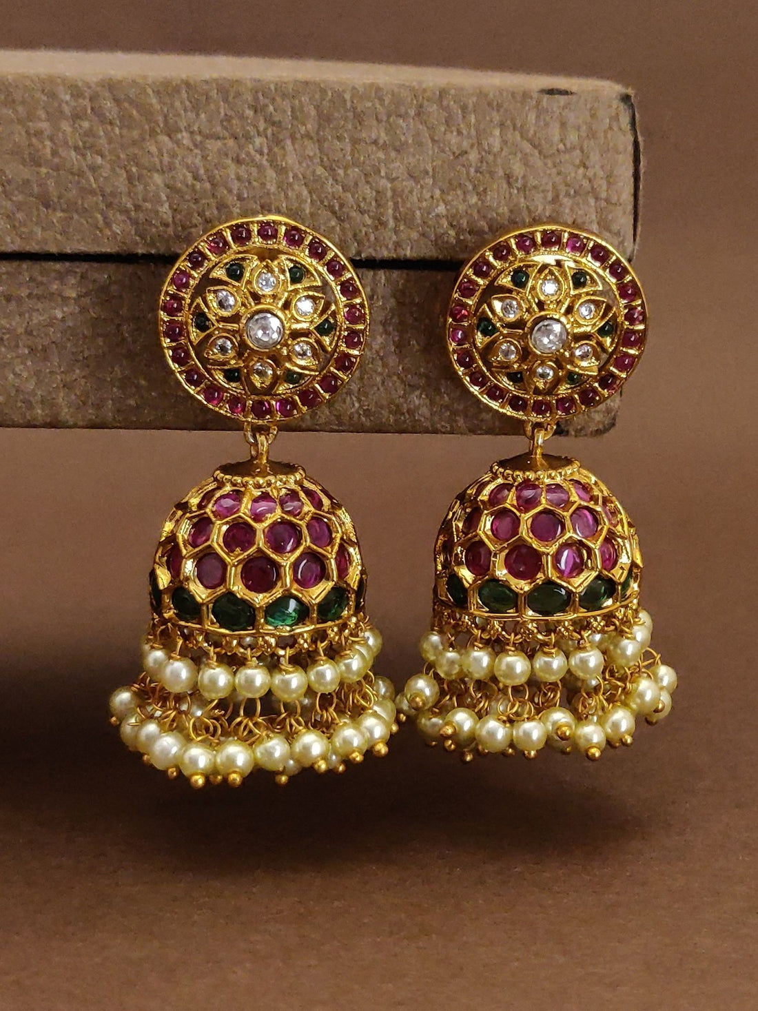 Traditional indian gold plated Jumka earrings with intricate floral design, pink and green enamel, and pearl detailing