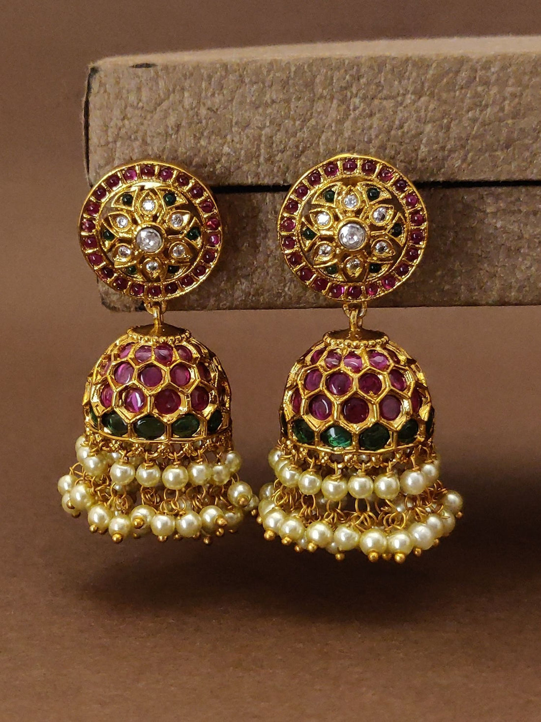 Traditional indian gold plated Jumka earrings with intricate floral design, pink and green enamel, and pearl detailing