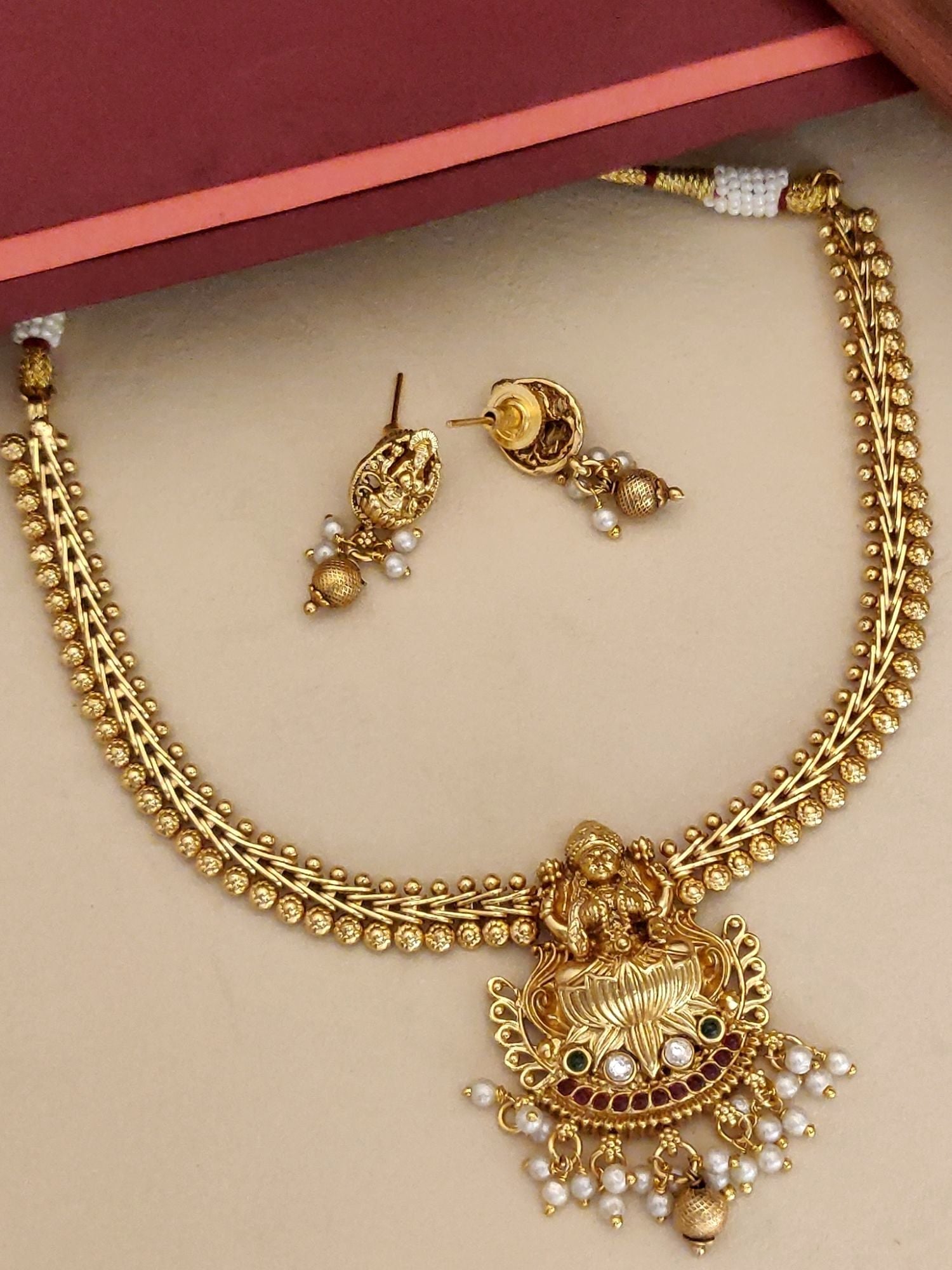 Traditional Indian Jewelry necklace with intricate gold design and matching earrings for festive occasions