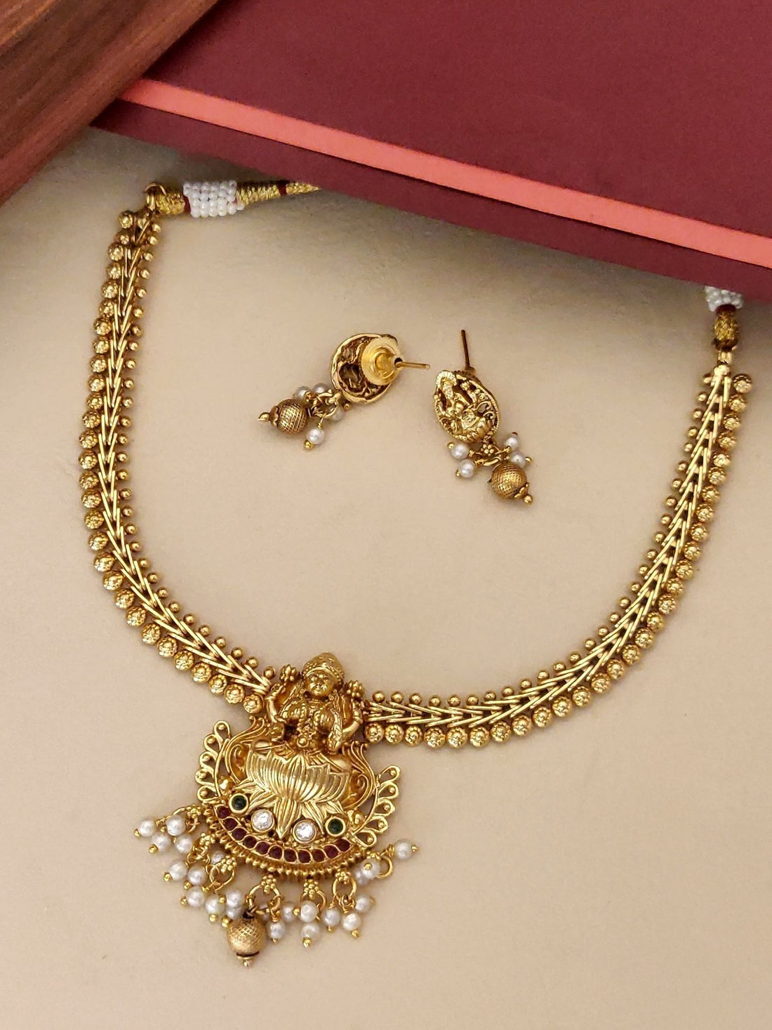 Traditional Indian Jewelry Necklace with Gold Finish and Pearl Details, paired with matching earrings