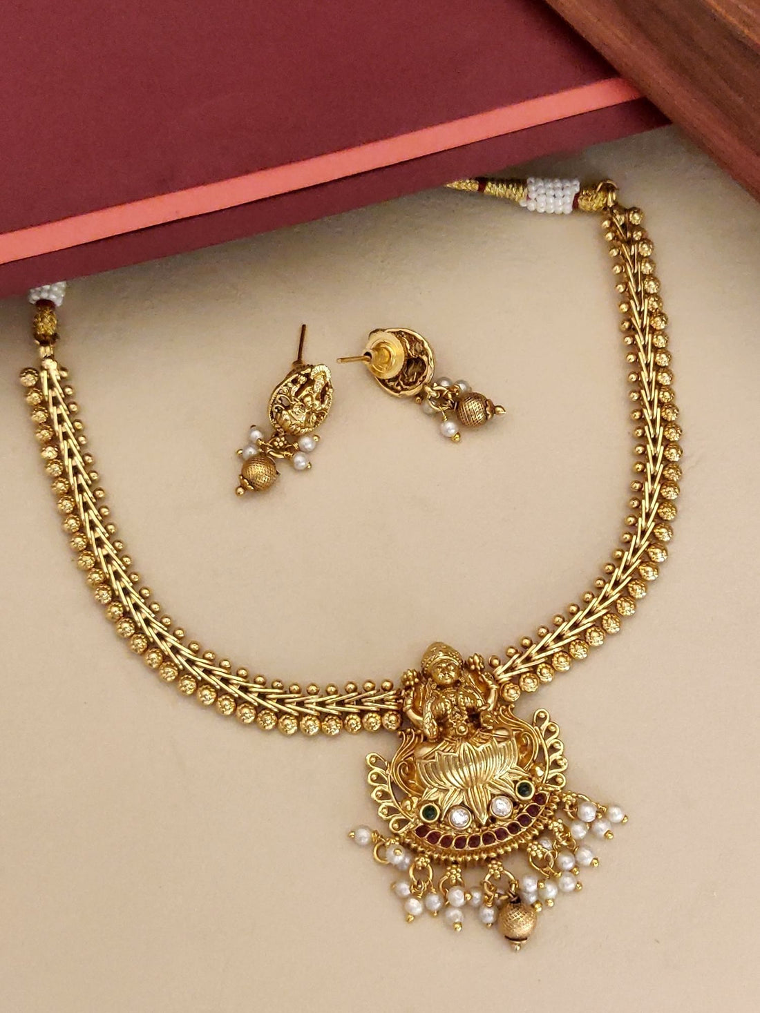 Traditional Indian Jewelry Necklace with Gold Finish and Pearl Details, paired with matching earrings