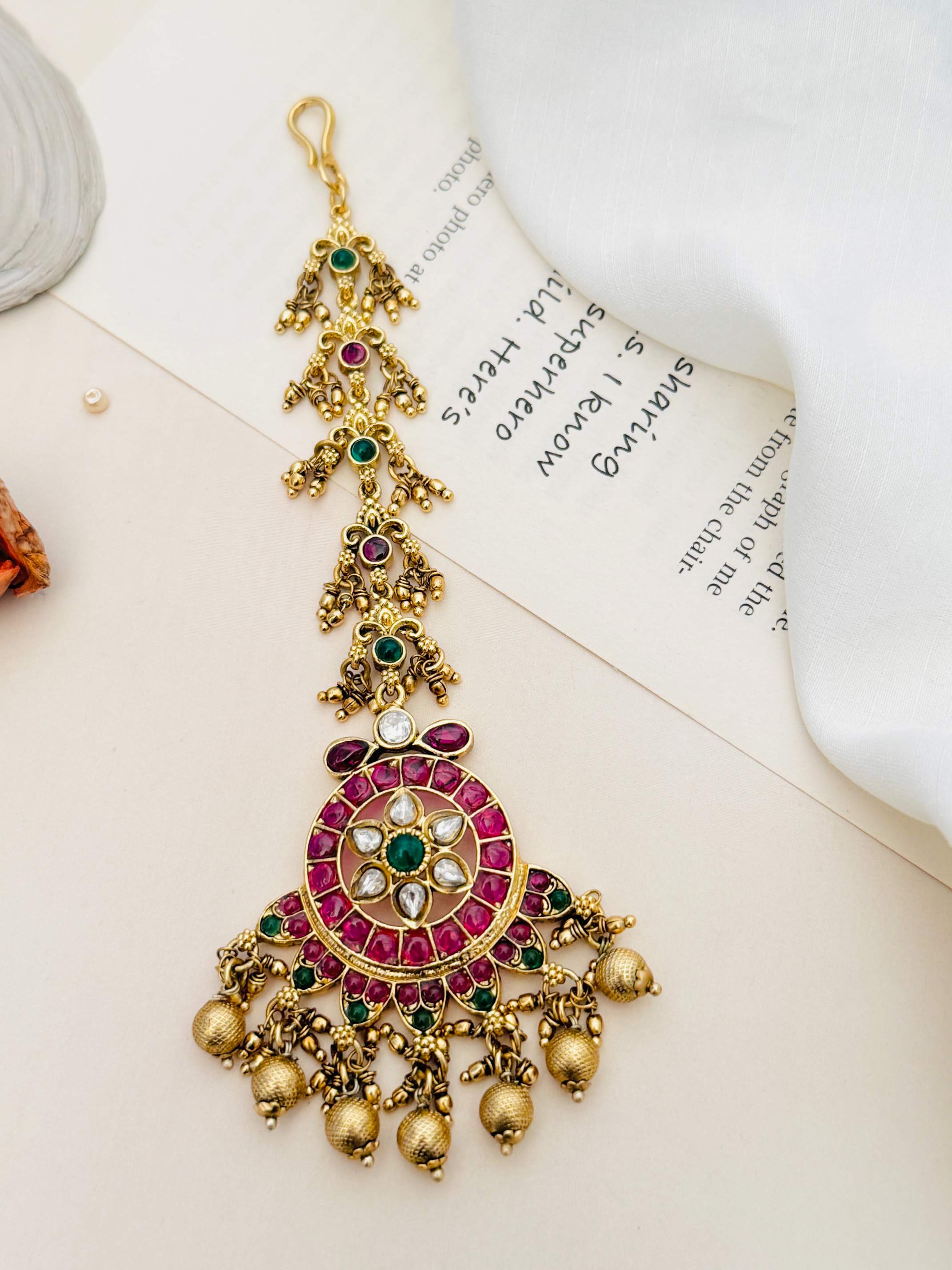 Traditional Matt Gold Plated Temple Maangtikka with red and green stones and intricate beadwork from Abdesignsjewellery