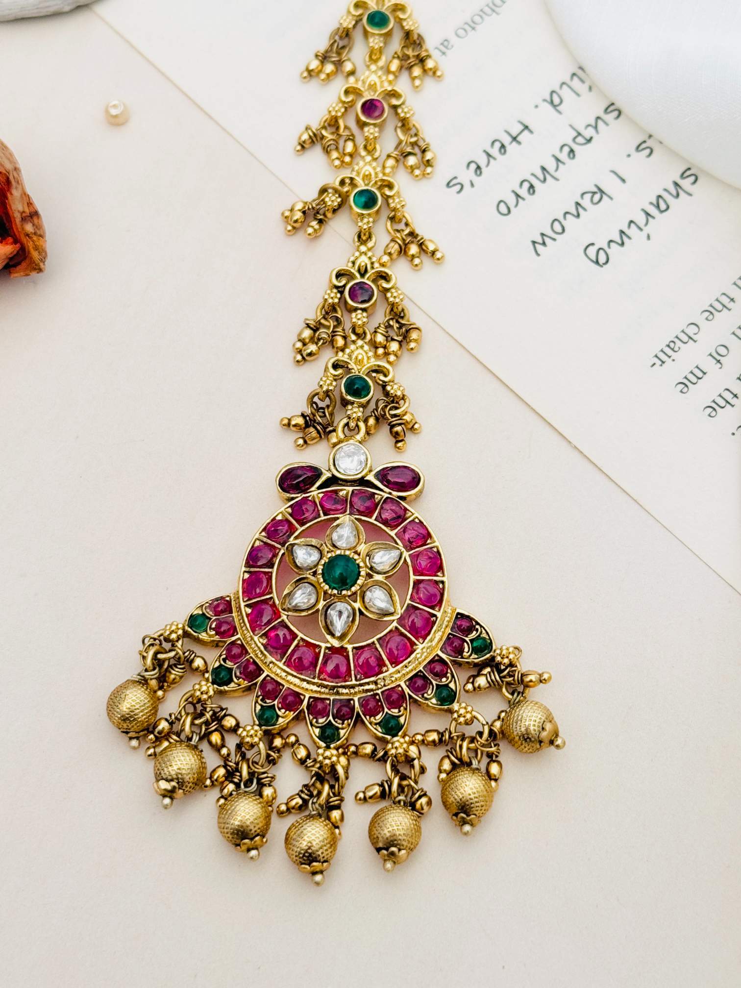Traditional Matt Gold Plated Temple Maangtikka with red and green stones and hanging gold beads