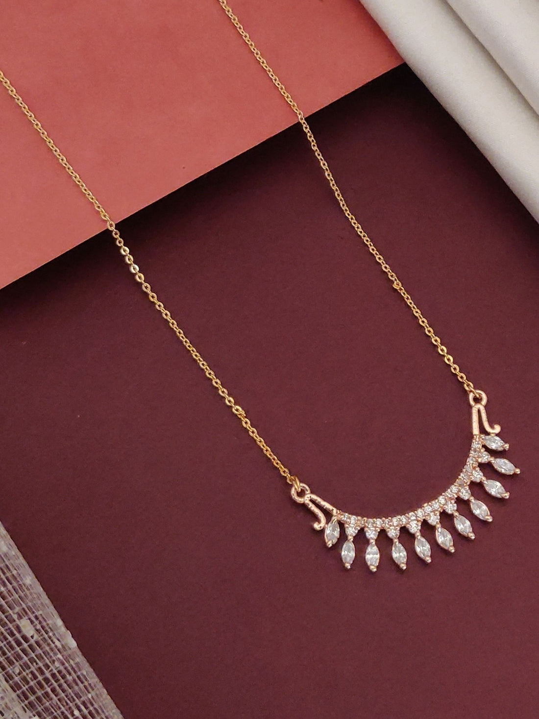 Trendy artificial jewelry pendant with sparkling stones on a delicate gold chain