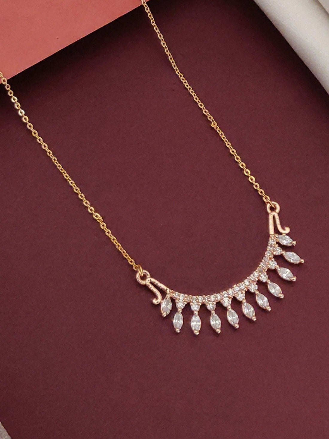 Trendy artificial jewelry pendant with sparkling stones on a delicate gold chain