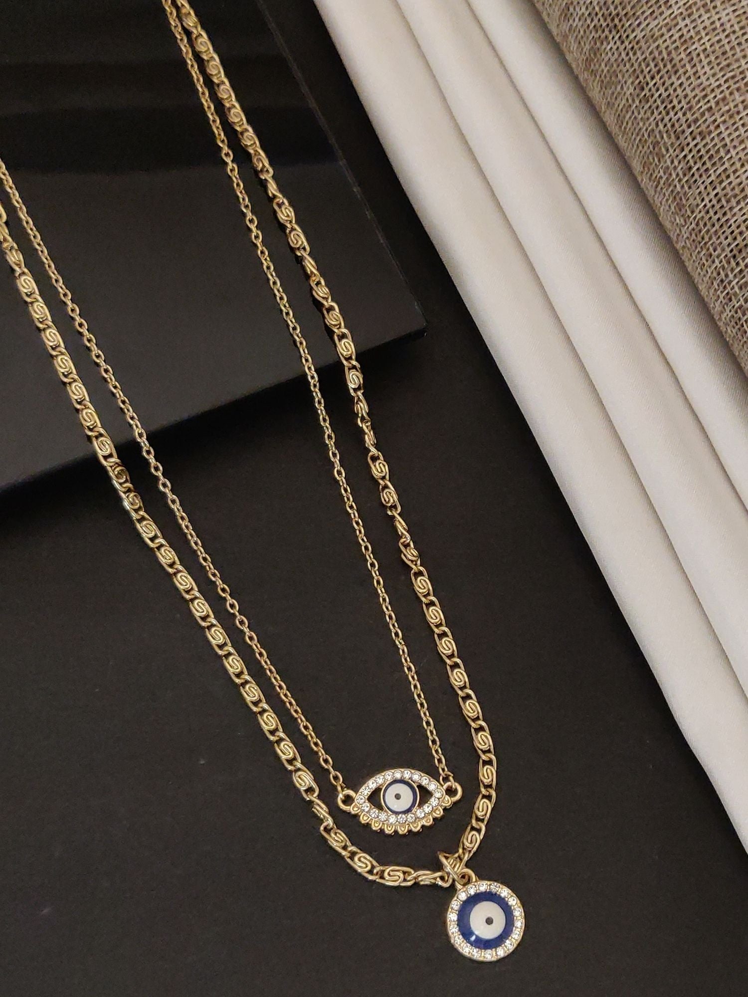 Western Gold Plated EvilEye Layered Necklace featuring intricate designs and stunning layering