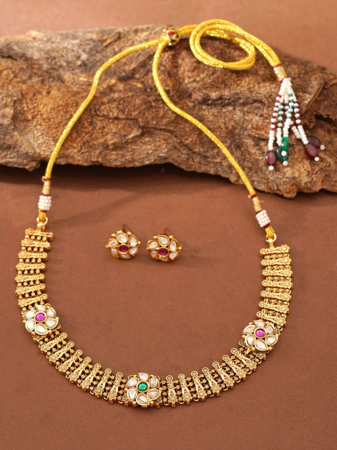 Abdesignsjewellery model wearing gold floral premium designer choker necklace India with gemstone accents