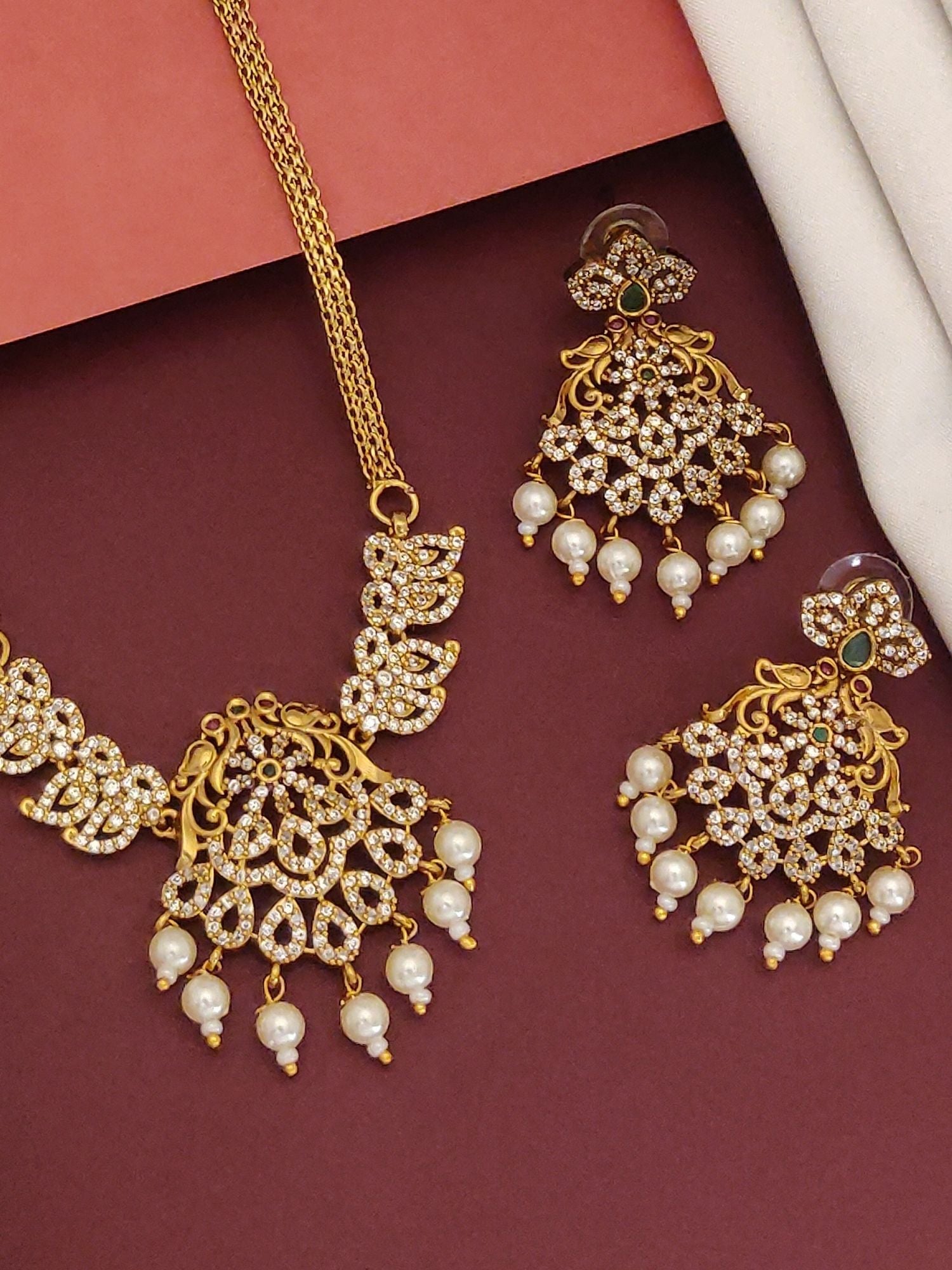 Mesmerising Gold plated American diamond necklace Set. Intricate gold necklace with matching pearl drop earrings