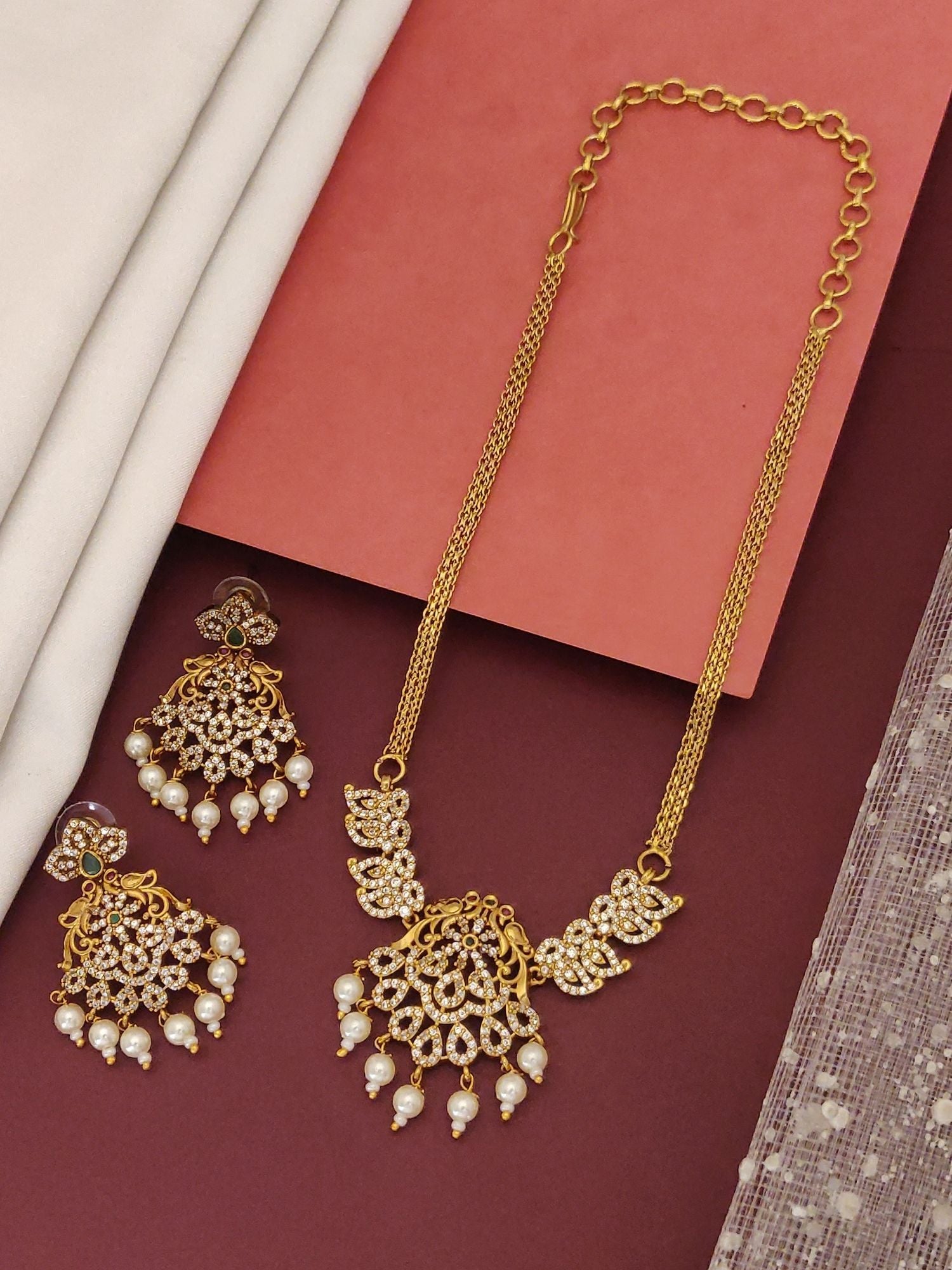 Mesmerising Gold plated American diamond necklace Set. Gold pendant necklace with matching chandelier earrings and pearl drops