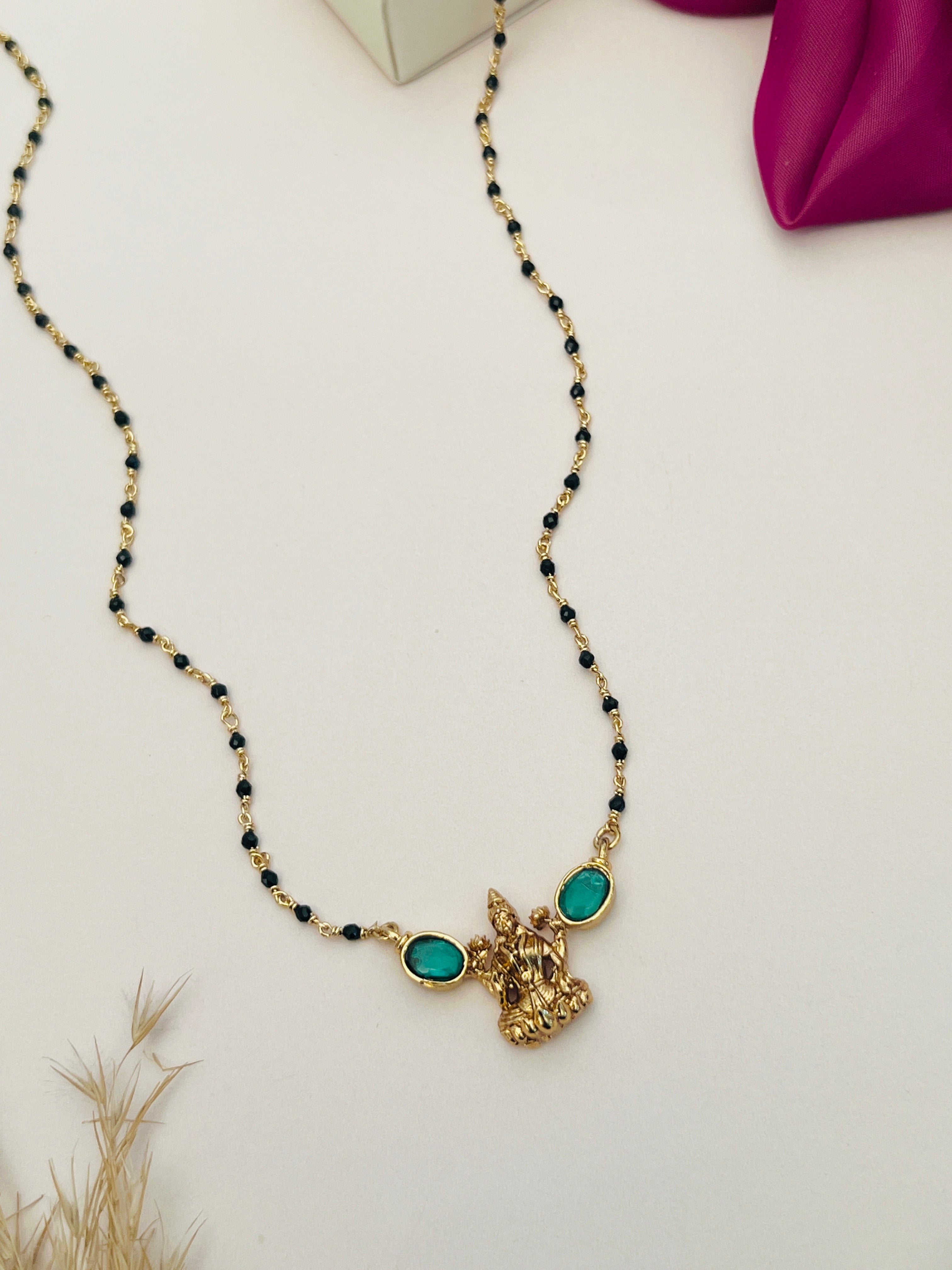 Laxmi Matt Antique Gold Plated Mangalsutra with green stone accents and black bead chain by Abdesignsjewellery