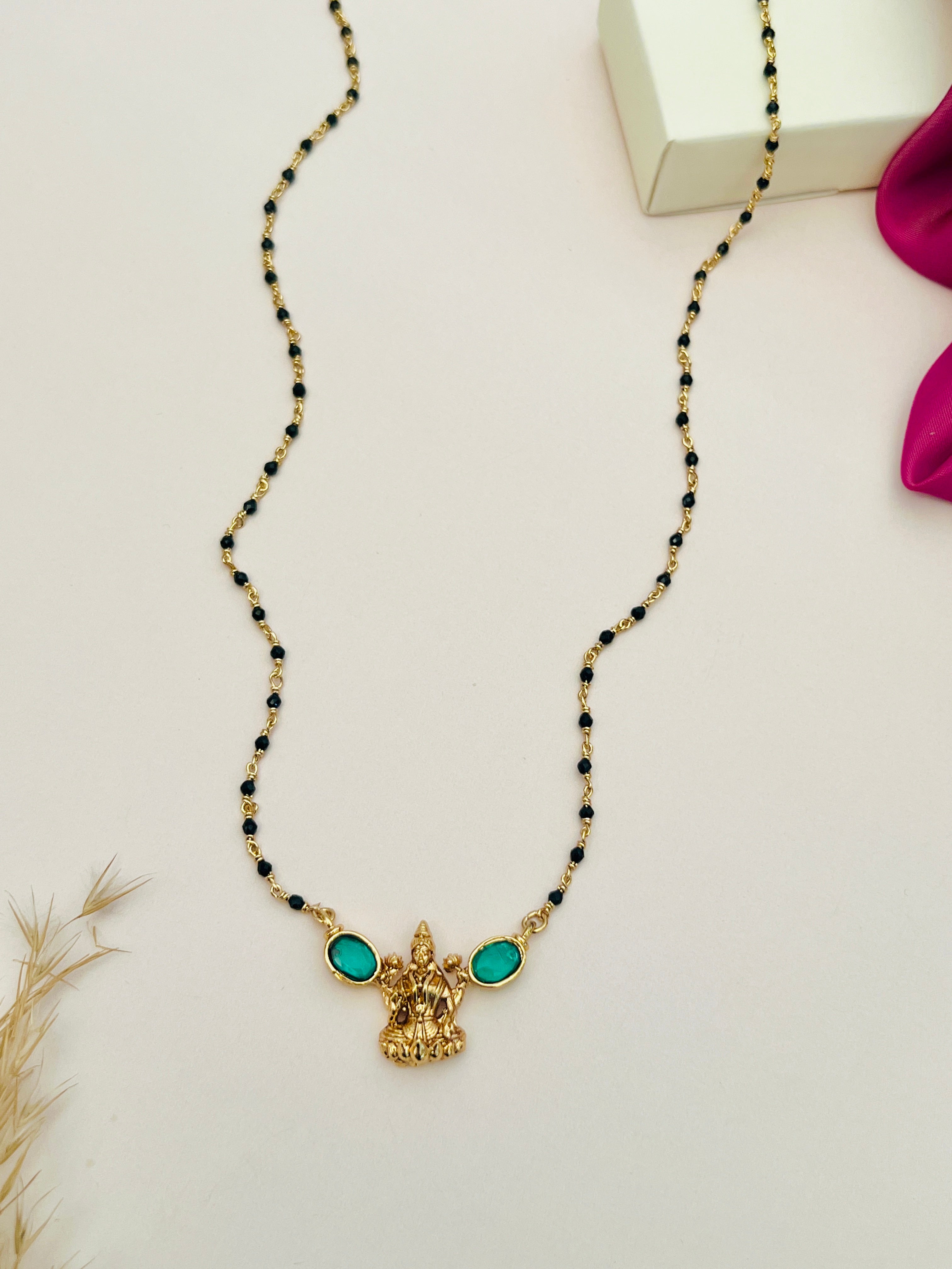 Laxmi Matt Antique Gold Plated Mangalsutra with black beads and green stone embellishments by Abdesignsjewellery