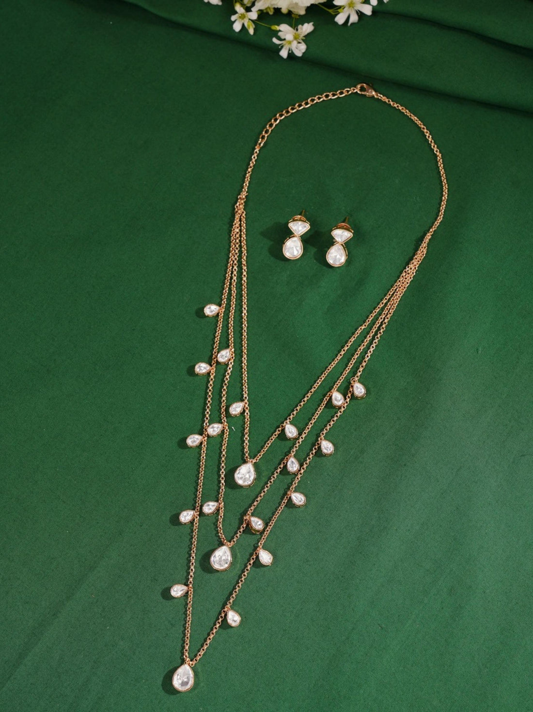 Layered Gold Plated Polki Pendant Chain worn by woman with white top and blue background