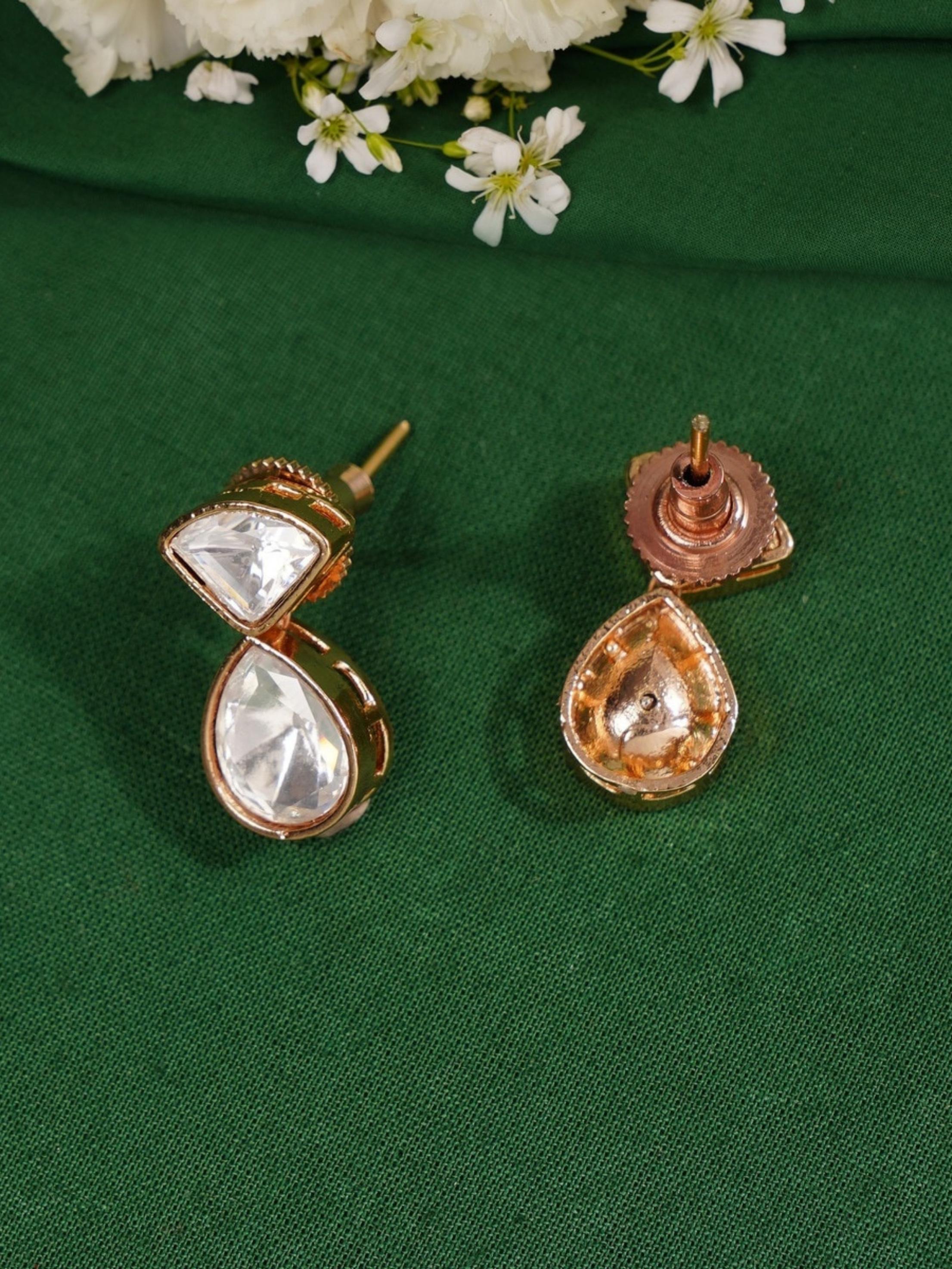 Layered Gold Plated Polki Pendant Chain earrings with teardrop and triangular clear stones on green fabric