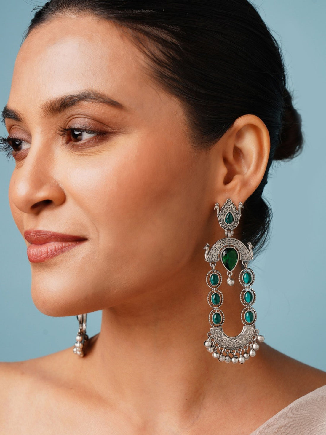 Long Peacock German Silver Earrings by Abdesignsjewellery worn by woman showcasing intricate green stone design
