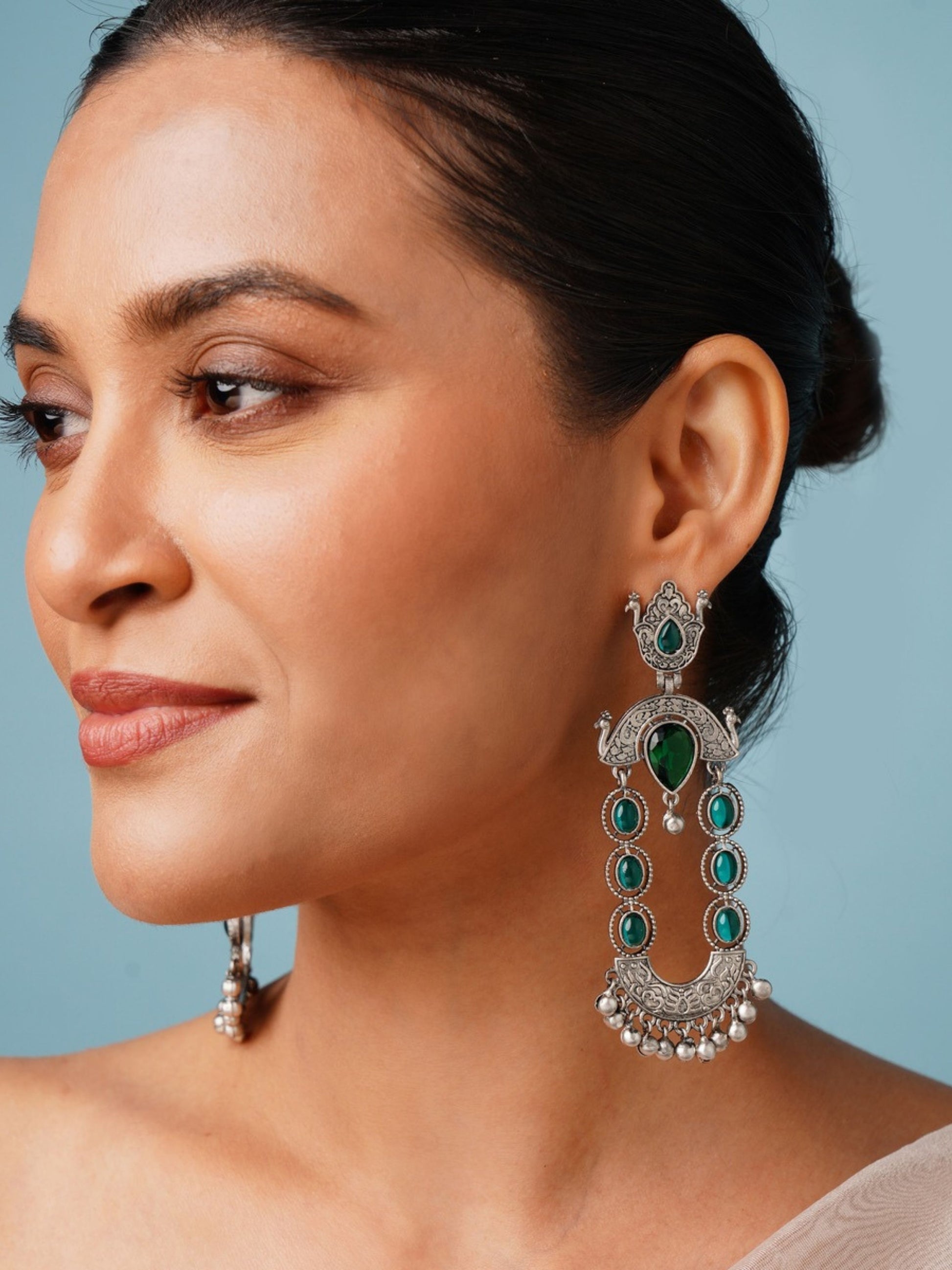 Long Peacock German Silver Earrings by Abdesignsjewellery worn by woman showcasing intricate green stone design