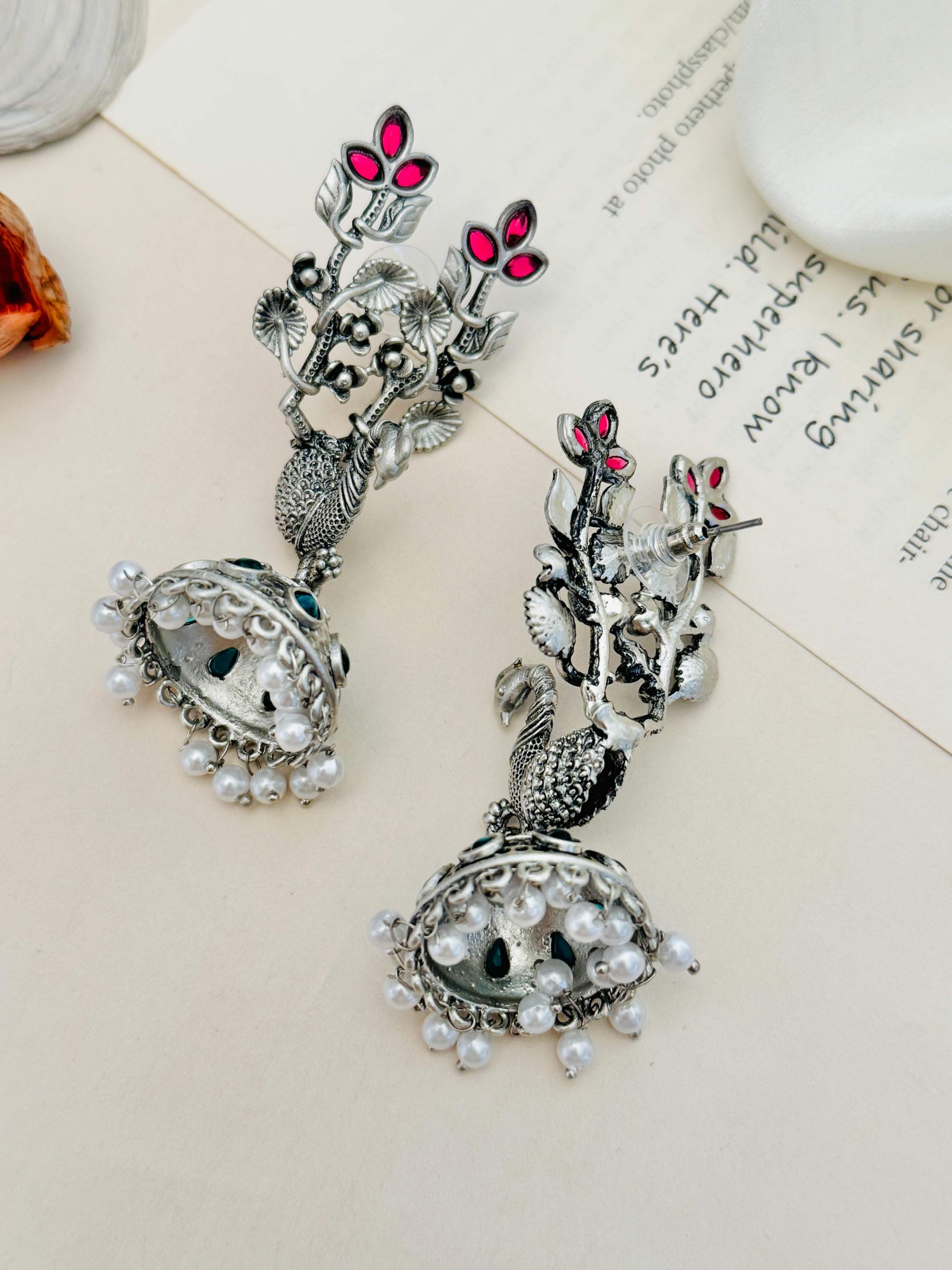 Long Peacock German Silver Plated Earrings with intricate floral design and pearl accents by Abdesignsjewellery
