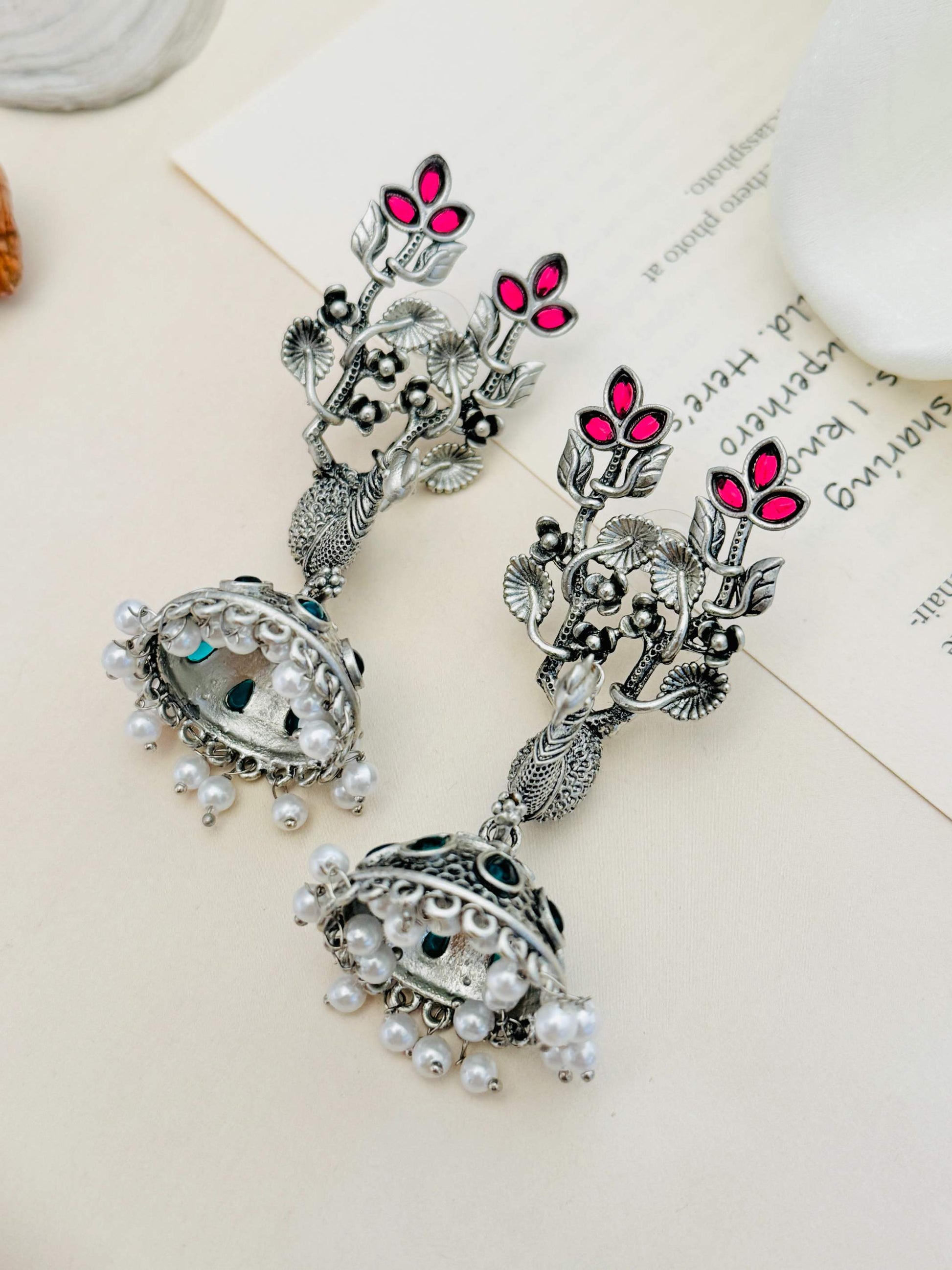 Long Peacock German Silver Plated Earrings by Abdesignsjewellery with floral design and pearl accents