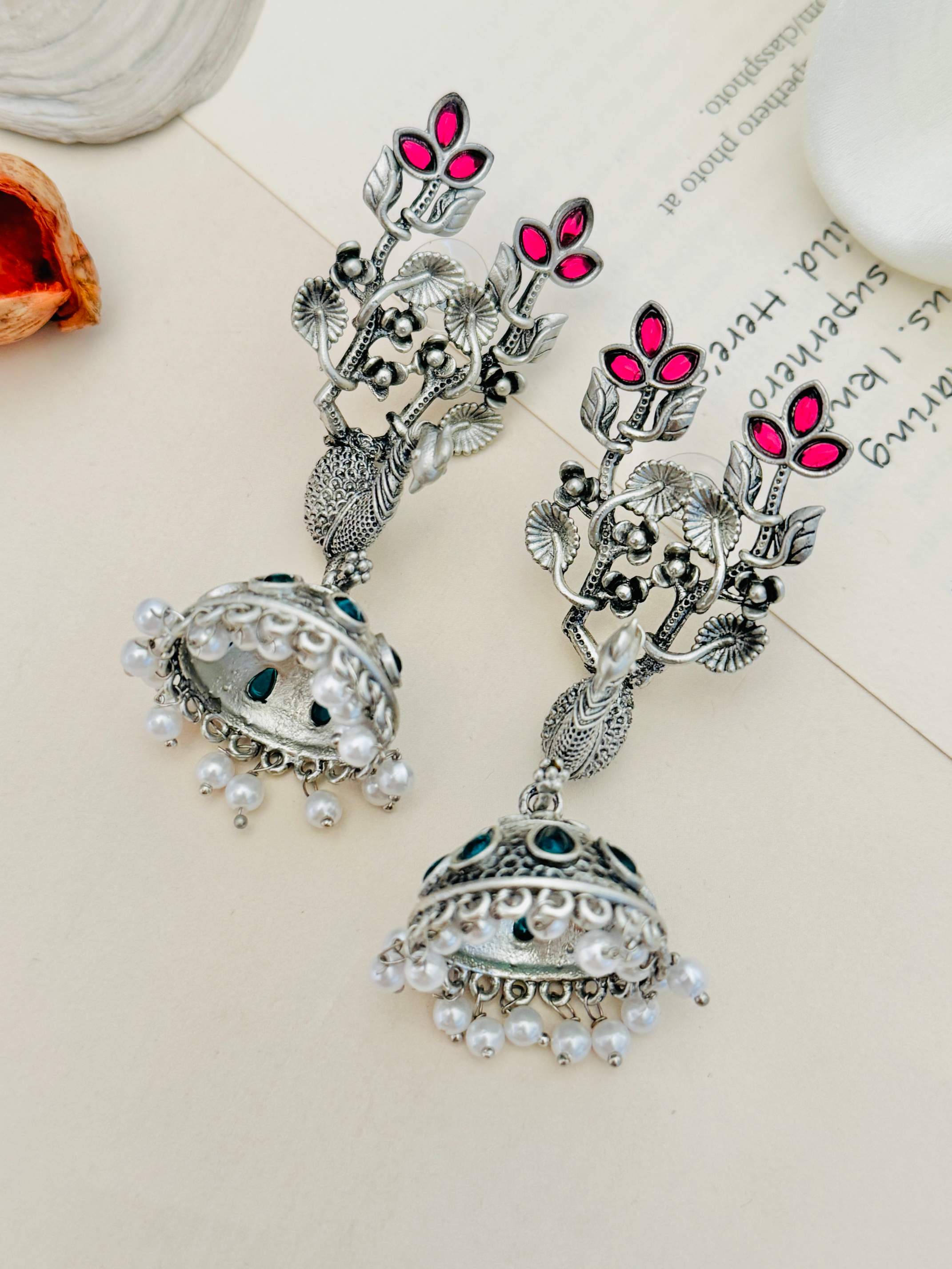 Long Peacock German Silver Plated Earrings by Abdesignsjewellery with intricate floral design and pearl accents