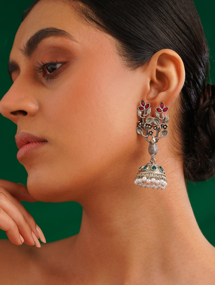 Long Peacock German Silver Plated Earrings by Abdesignsjewellery worn by woman with intricate peacock design and pearl detailing