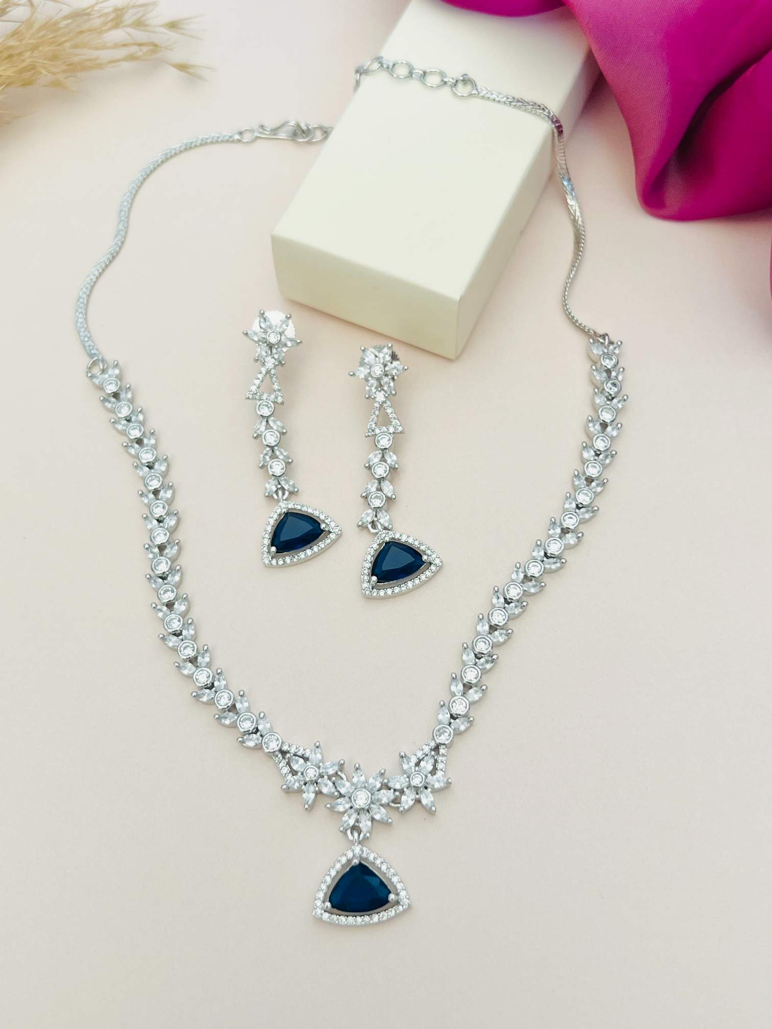 Luxurious Silver Plated American Diamond Necklace with matching earrings featuring blue teardrop stones
