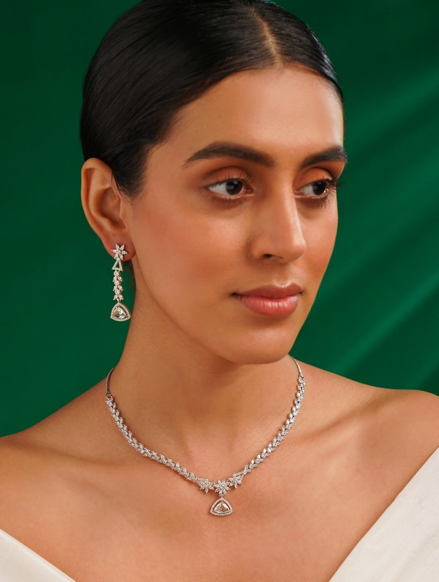 Luxurious Silver Plated American Diamond Necklace worn by woman with matching earrings on green background