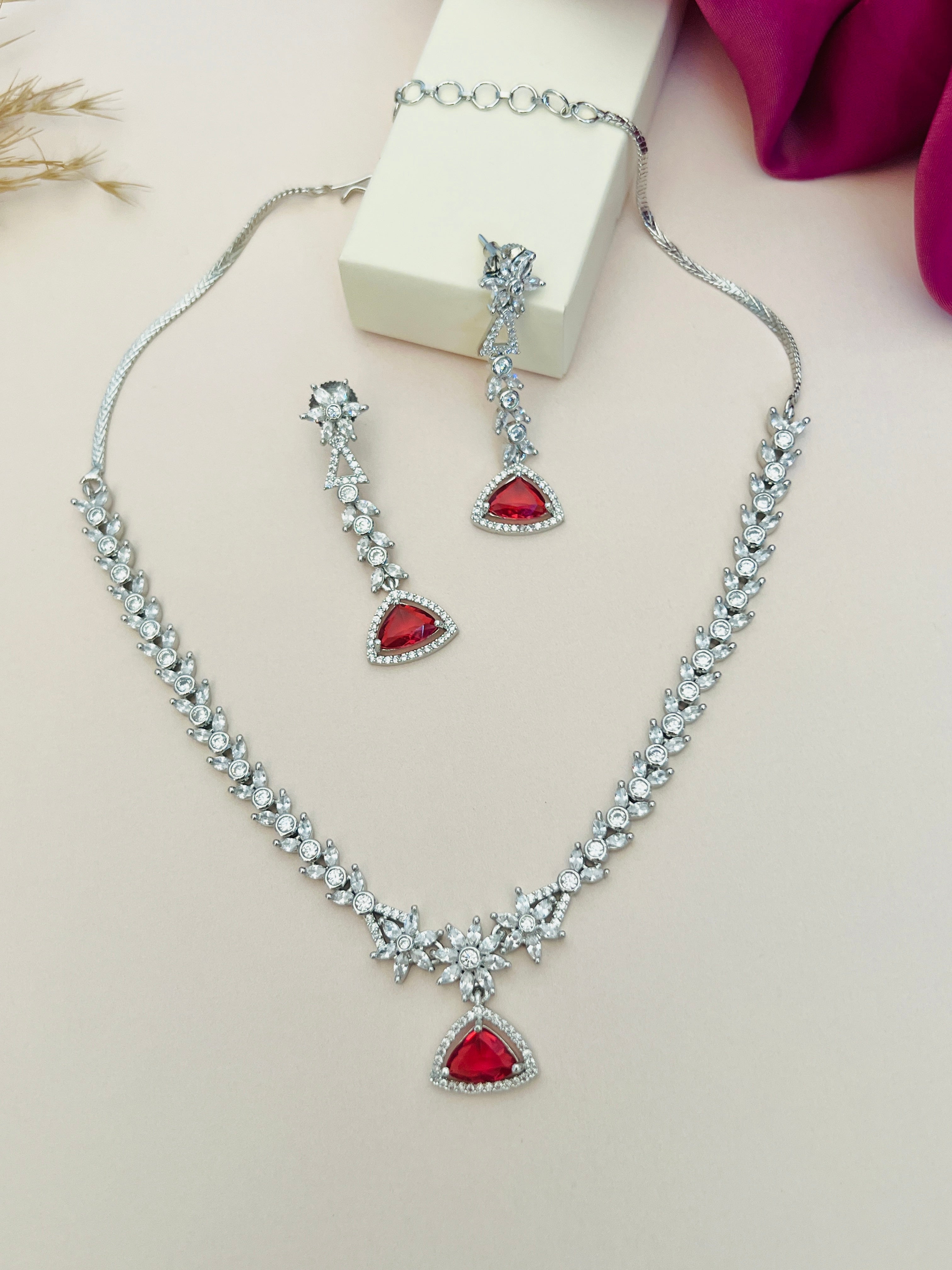 Luxurious Silver Plated American Diamond Necklace with red gemstone pendant and matching earrings by Abdesignsjewellery