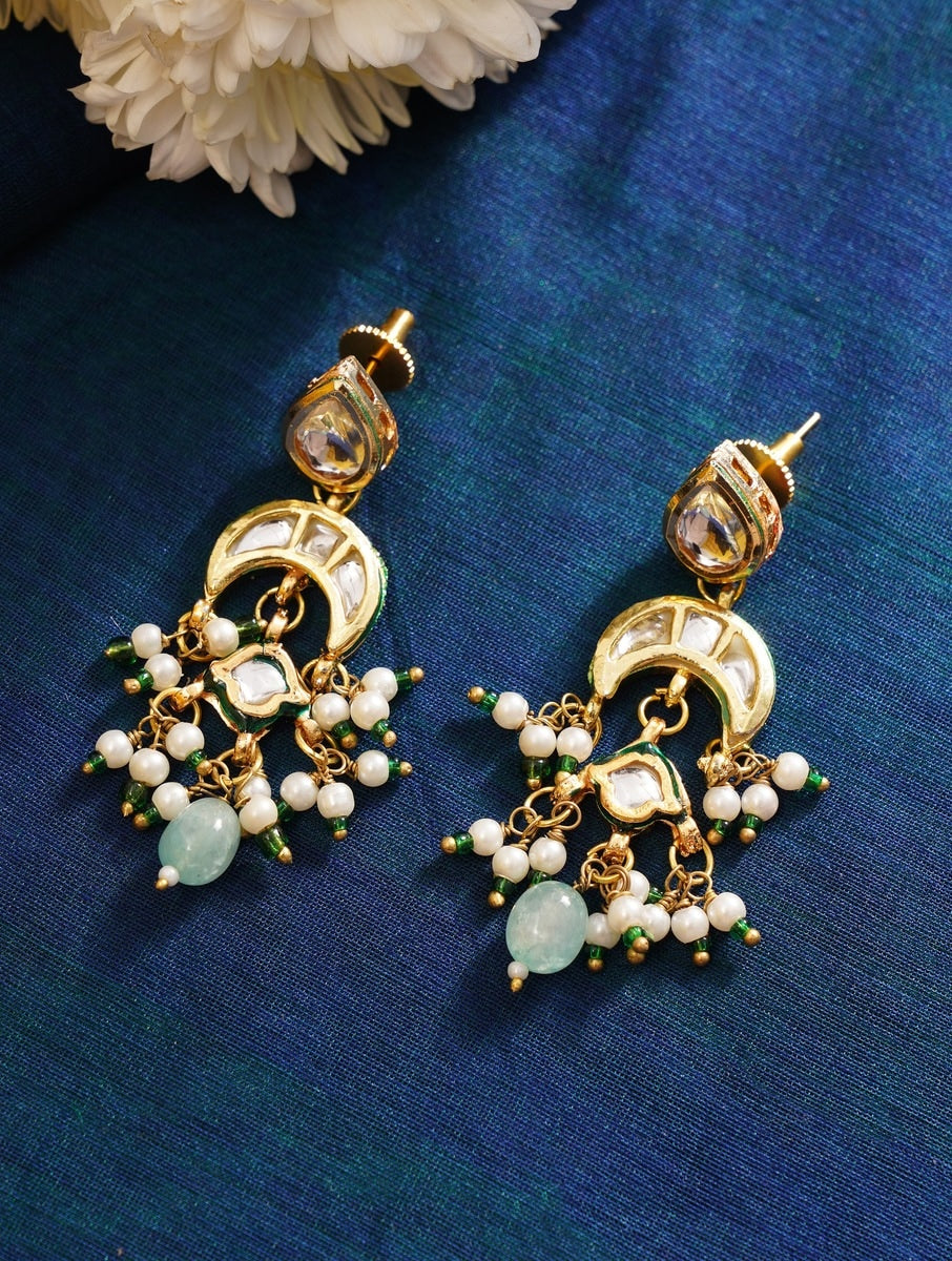 Maharani Green Meenakari Necklace Set gold and green intricate earrings with pearl accents on blue fabric by Abdesignsjewellery