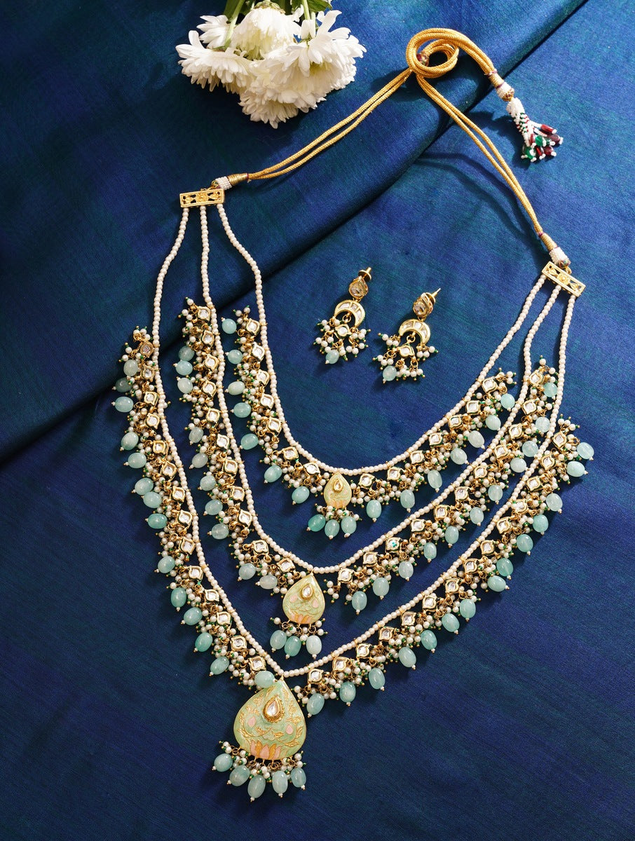 Abdesignsjewellery Maharani Green Meenakari Necklace Set with matching earrings on blue fabric