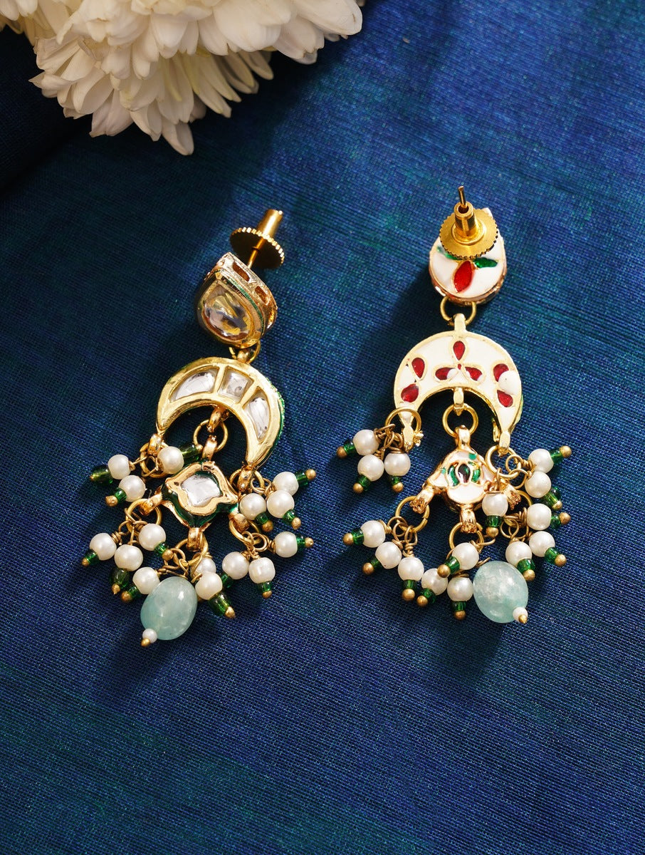 Maharani Green Meenakari Necklace Set earrings with white pearls and green gemstones on blue fabric