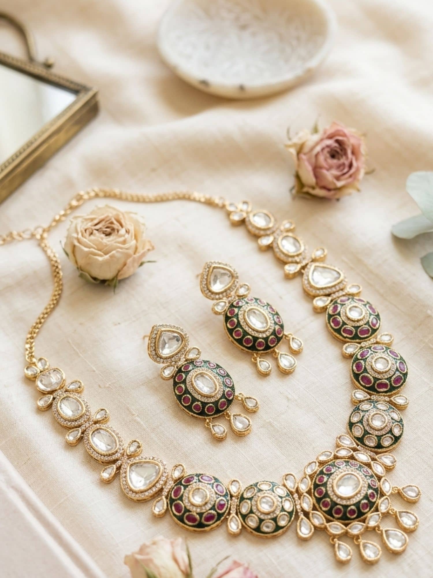 Elegant name gold plated necklace with colorful stones and matching earrings on a soft background